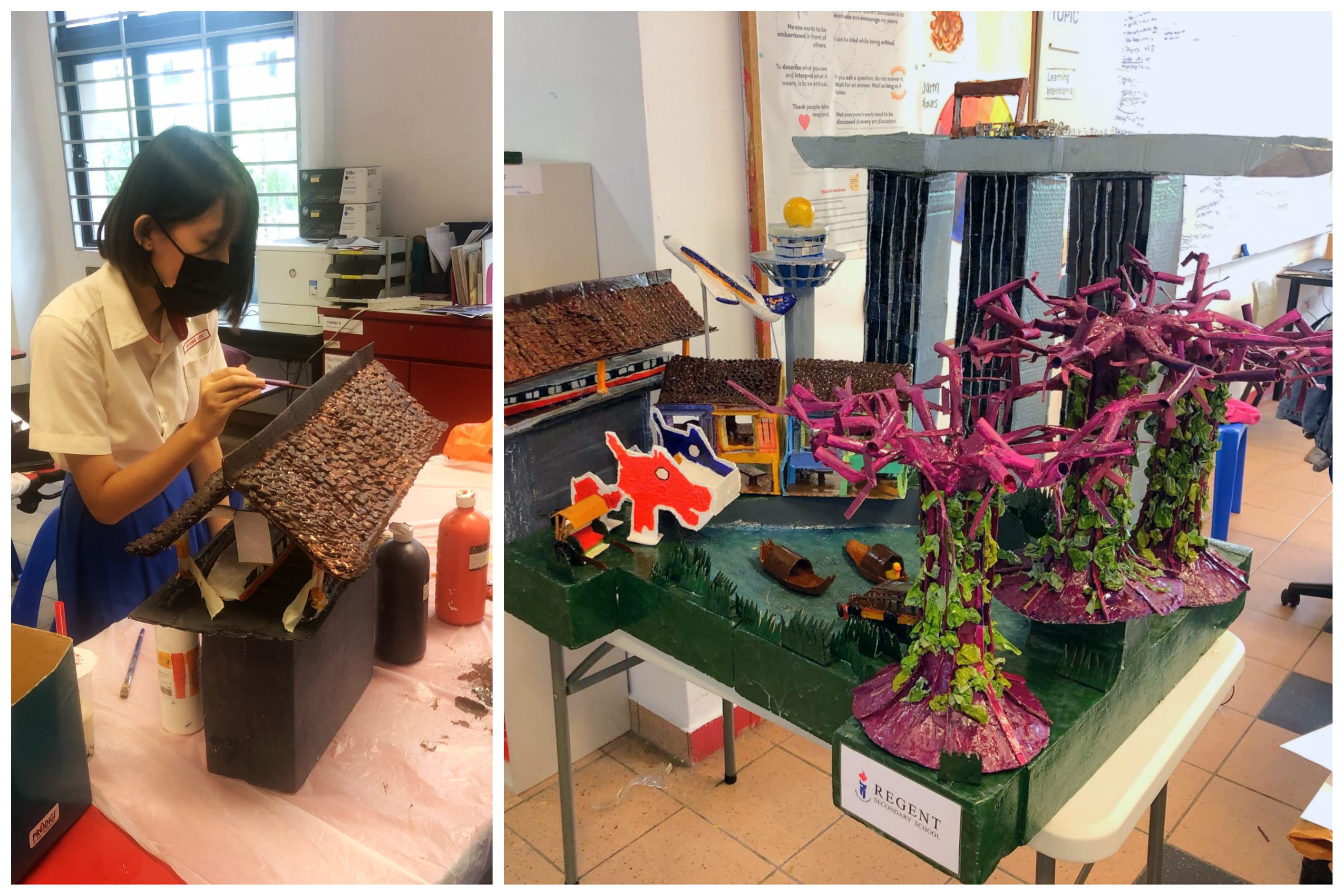 Student paints a roof model; beside it, a colorful diorama with purple trees, buildings, and a bridge.