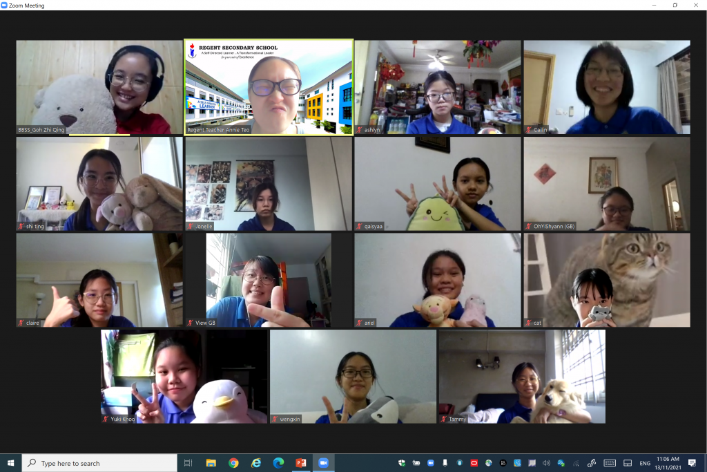 Zoom meeting with a teacher and students from Regent Secondary School, some holding stuffed animals and a cat.