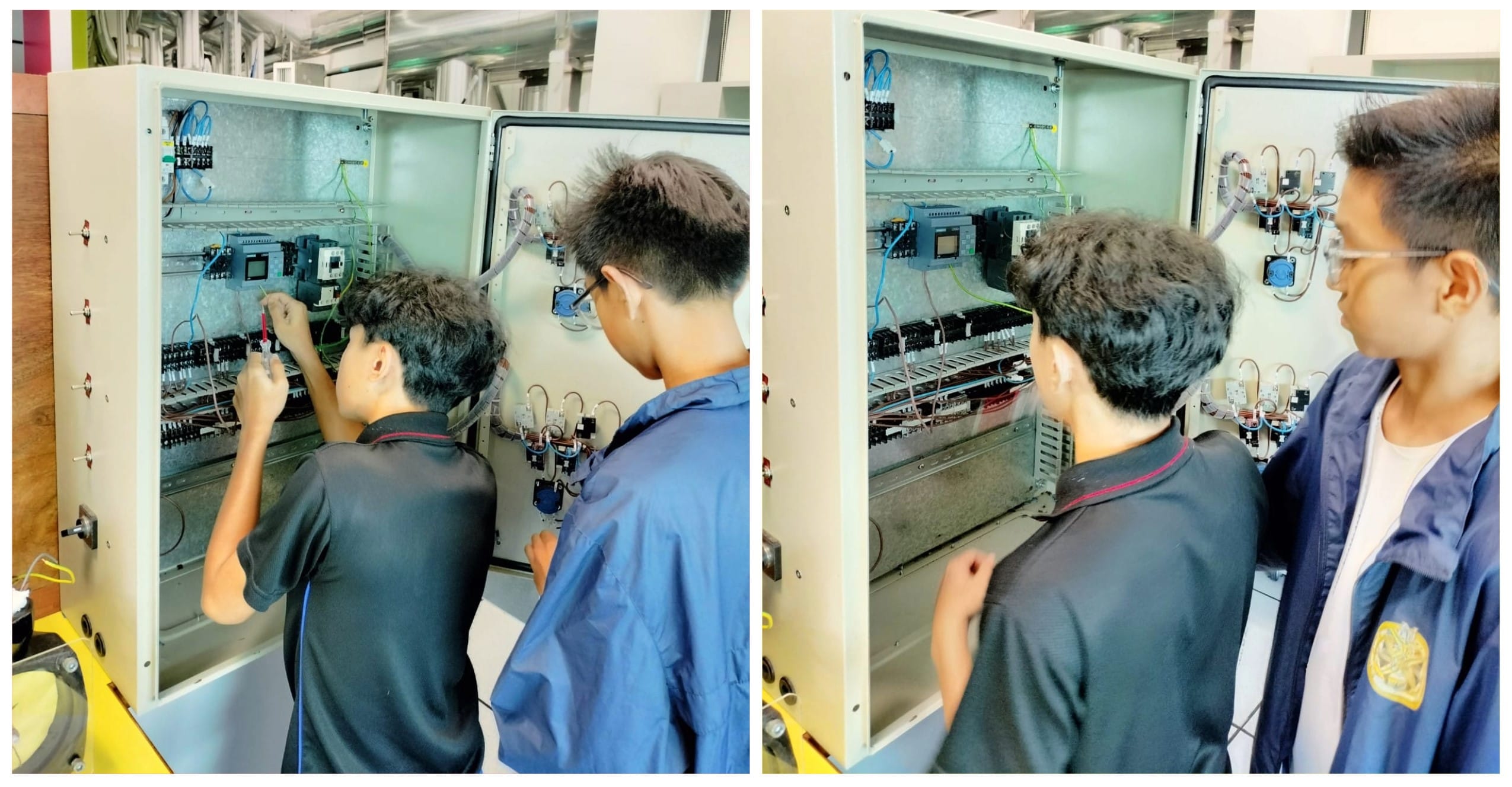 Two young men inspect and work on an open electrical control panel filled with wires and components.