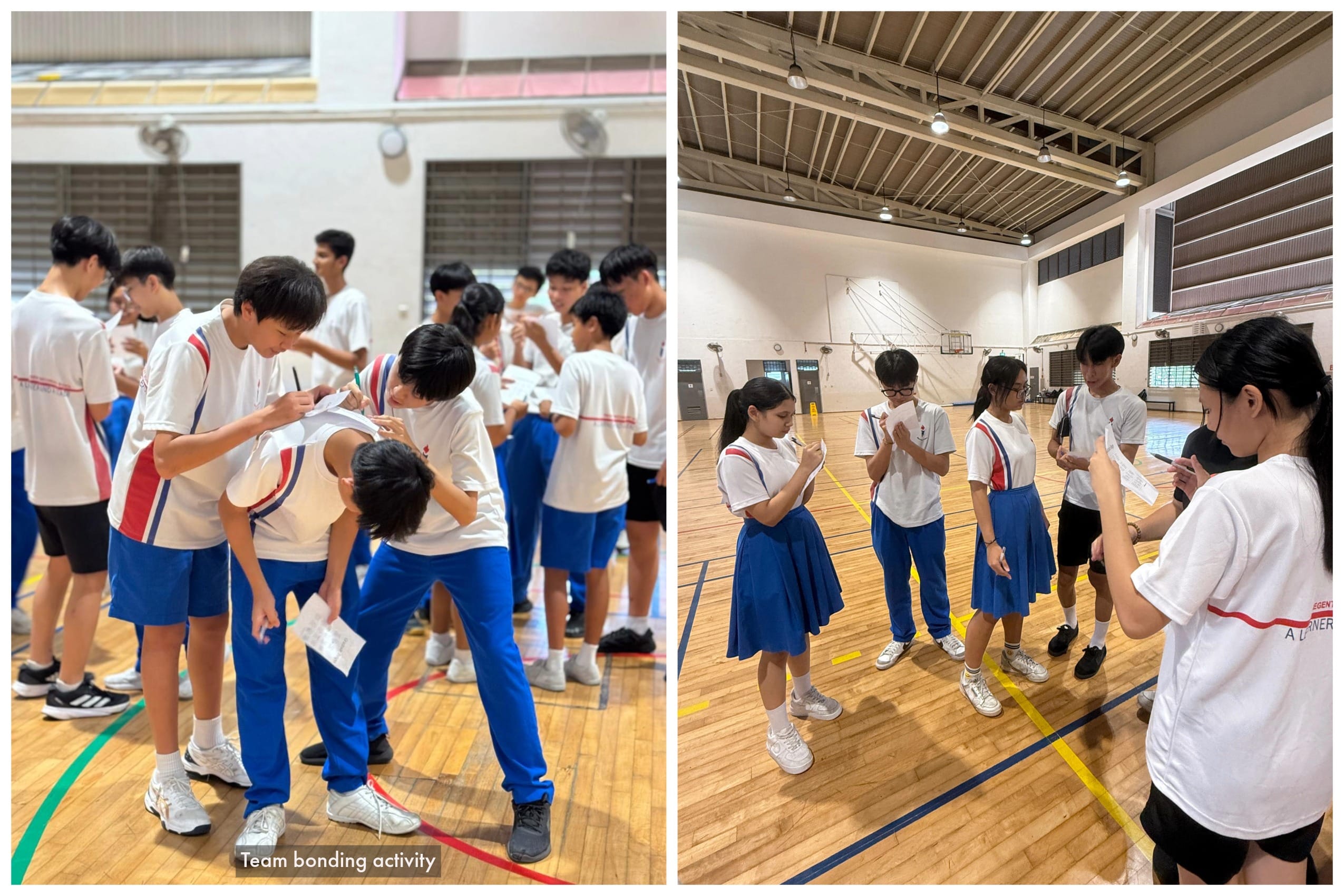 Students in white and blue uniforms gather in a gymnasium, reading papers during a team bonding activity.