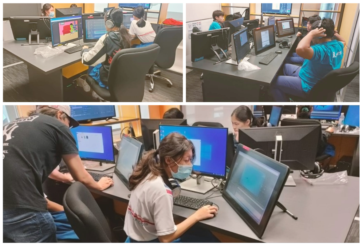 Students work at desktop computers in a lab, some wearing masks and headphones, with colorful software visible on screens.