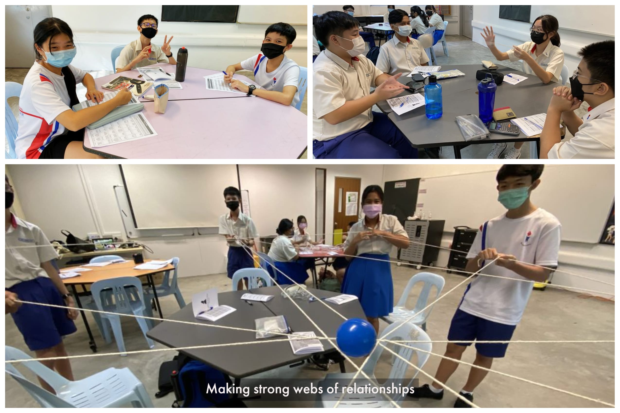 Masked students in uniform sit at tables discussing, and stand holding strings connected to a balloon in a classroom activity.
