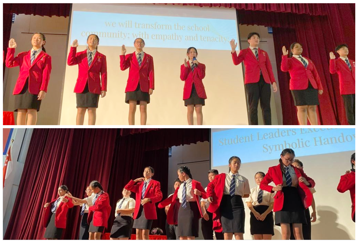 Students in red blazers take an oath on stage, then exchange jackets in a symbolic leadership handover ceremony.