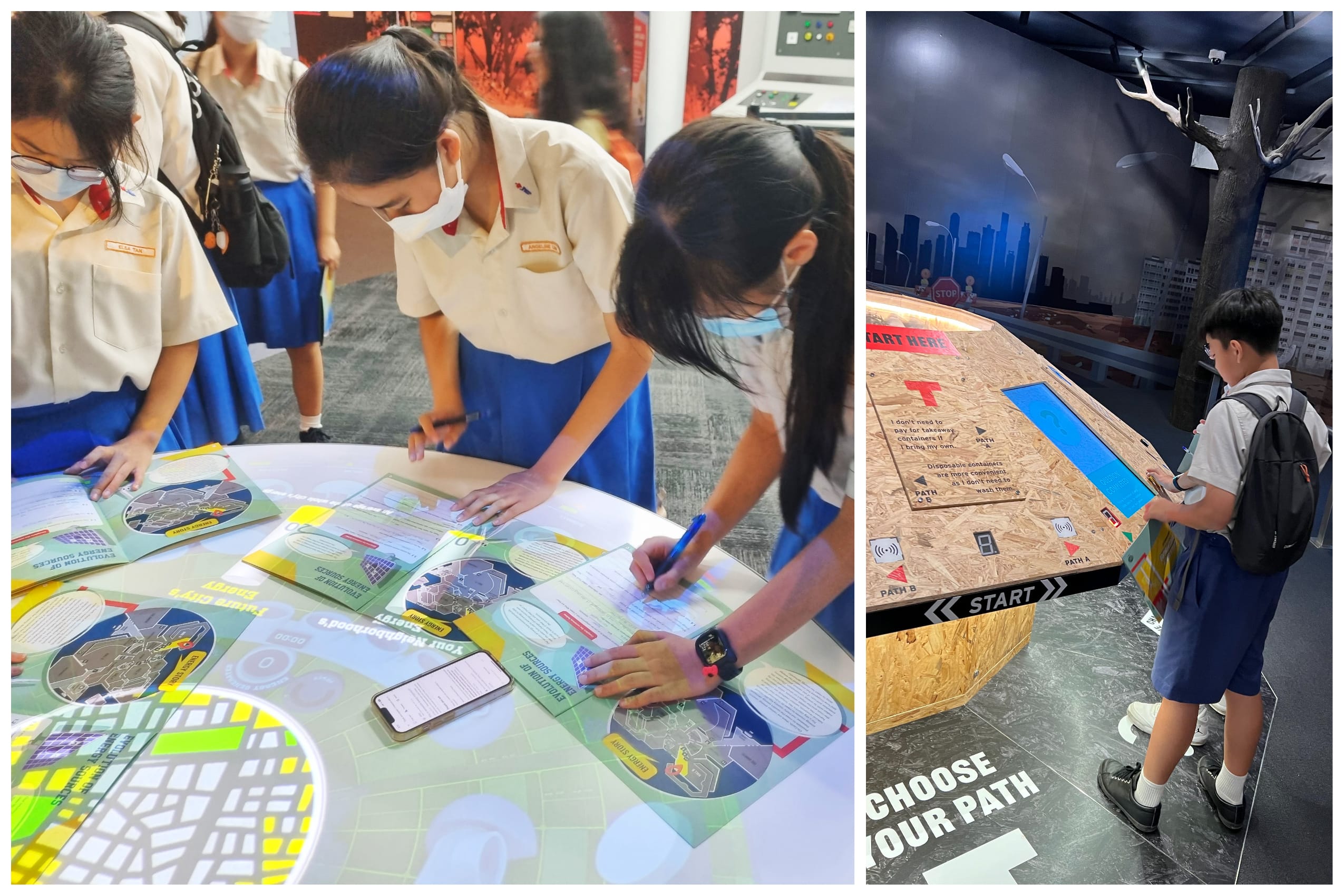 Students in uniforms and masks write on worksheets at a lit table; another student uses an interactive kiosk.