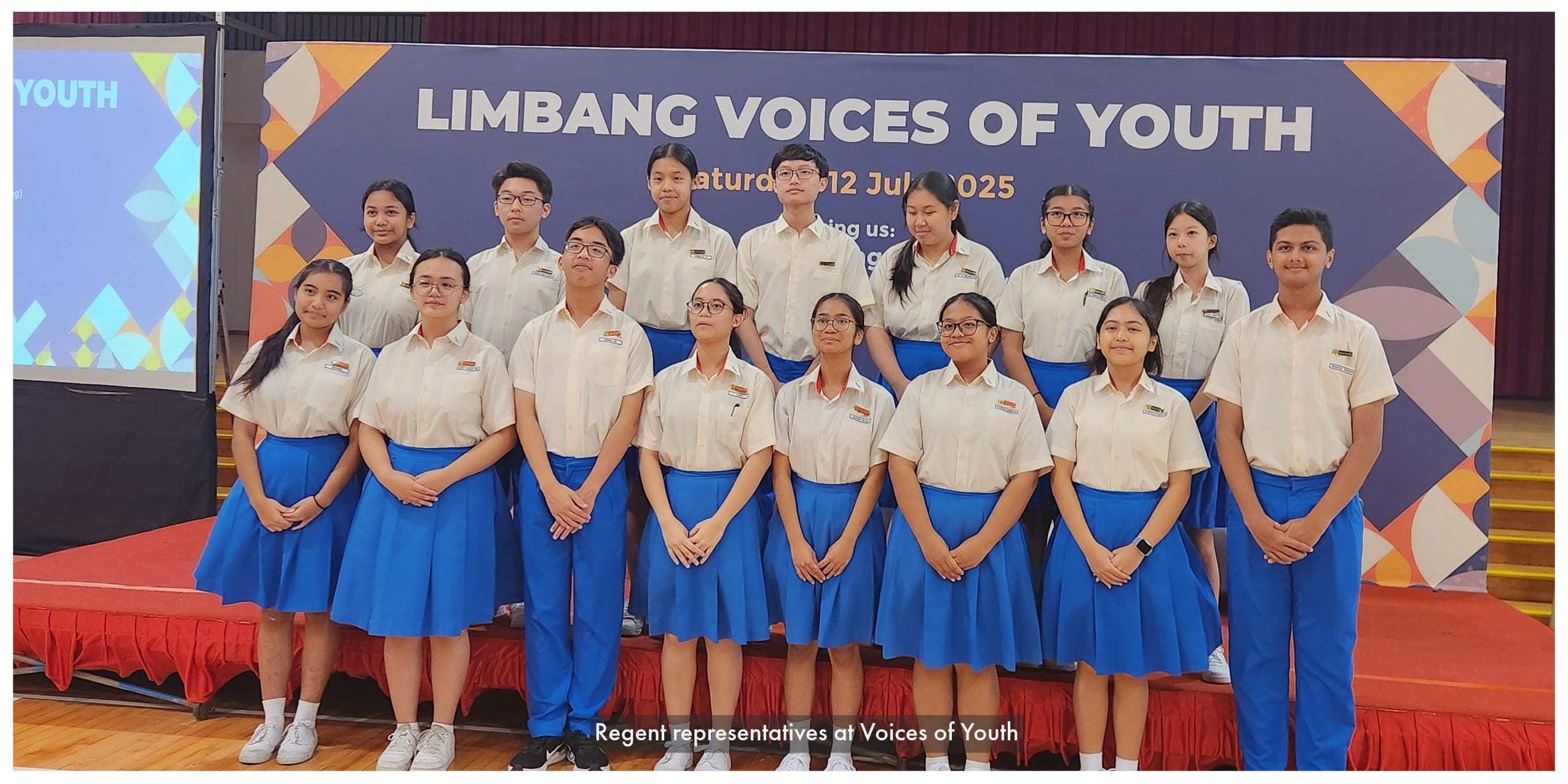 Students in white shirts and blue skirts pose in front of a Limbang Voices of Youth banner dated 12 July 2025.