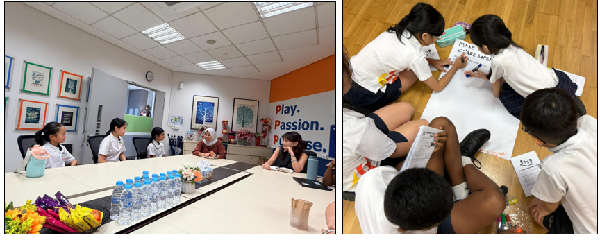 Students sit around a conference table on the left, while on the right, children write on a large poster on the floor.