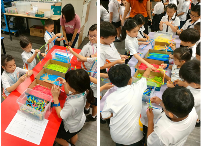 SPDS students gather around tables with colorful building pieces in boxes during a classroom activity.