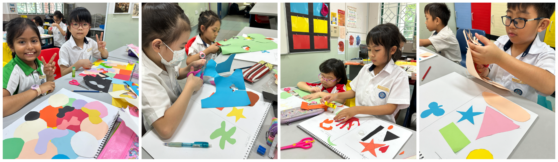 Young students in school uniforms cut and arrange colorful paper shapes on white boards in a classroom art activity.