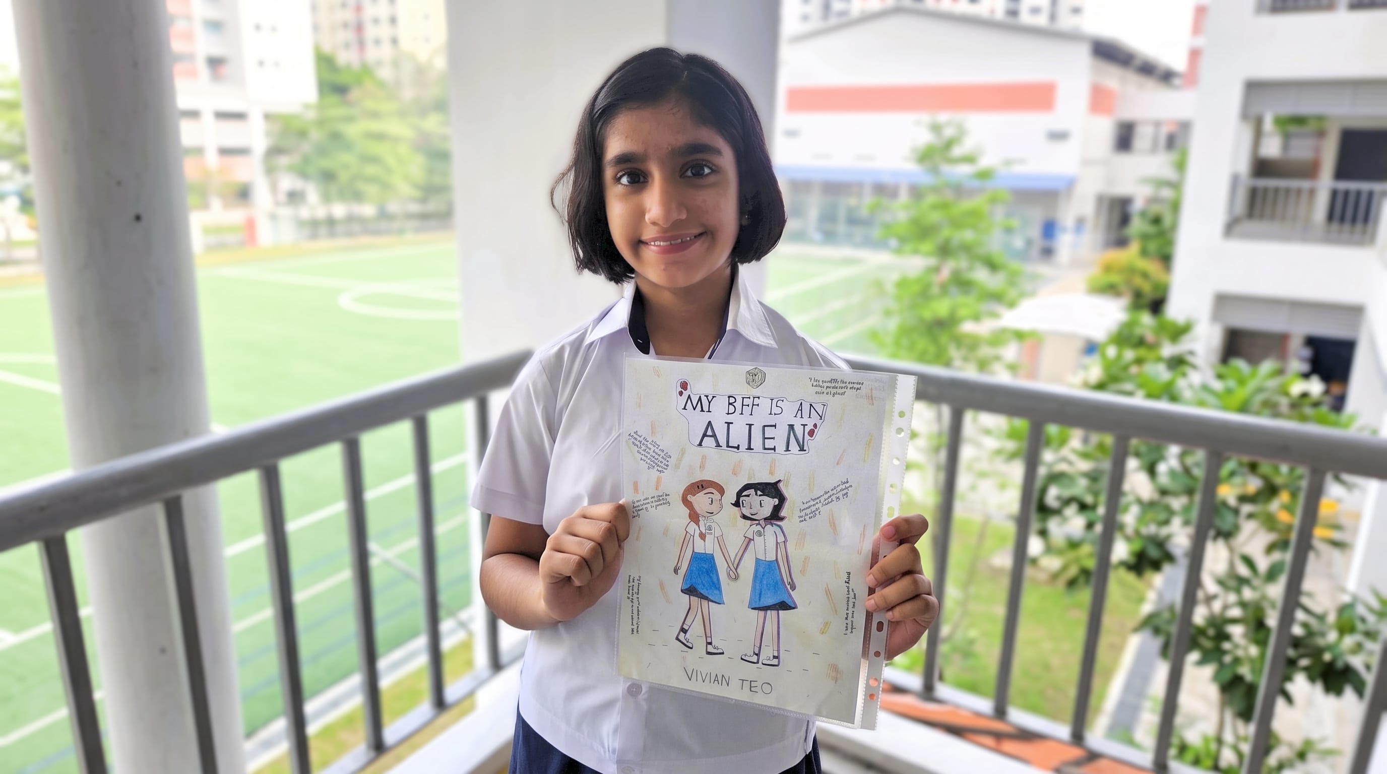 Gauri Nair holding her work of redesigning the cover page of My BFF is an Alien.