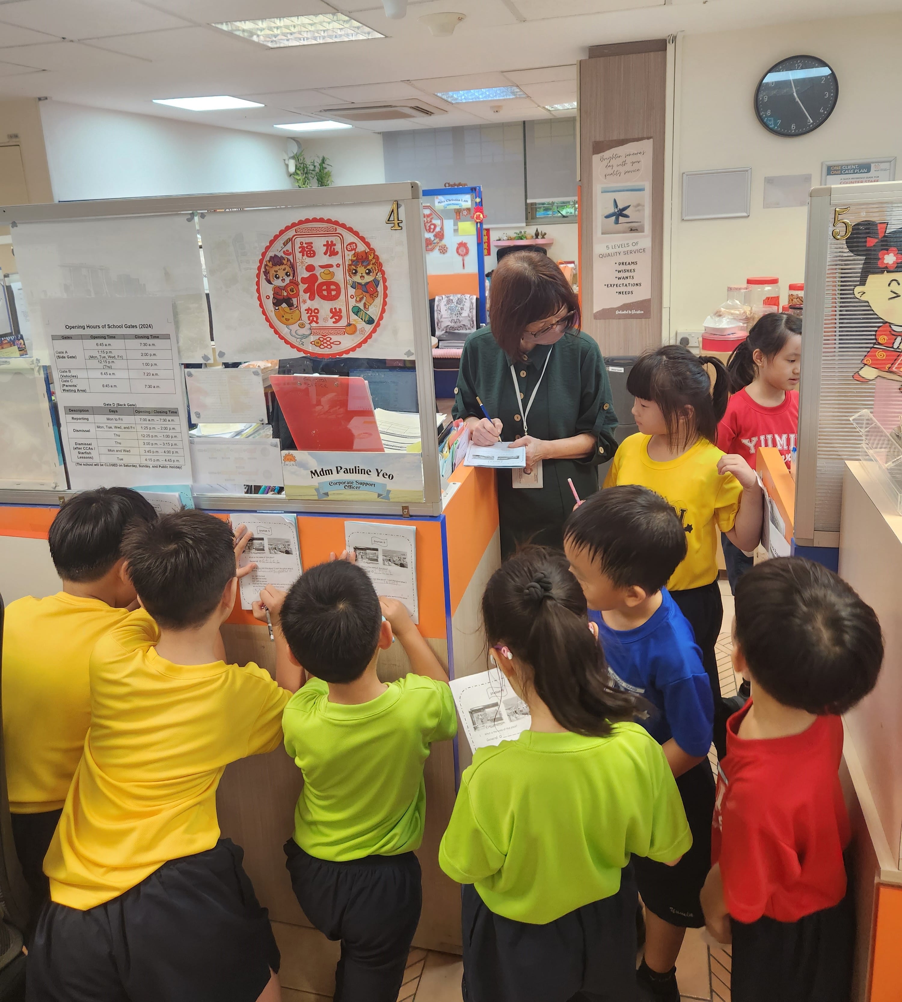 Students gather around our office staff and ask questions.