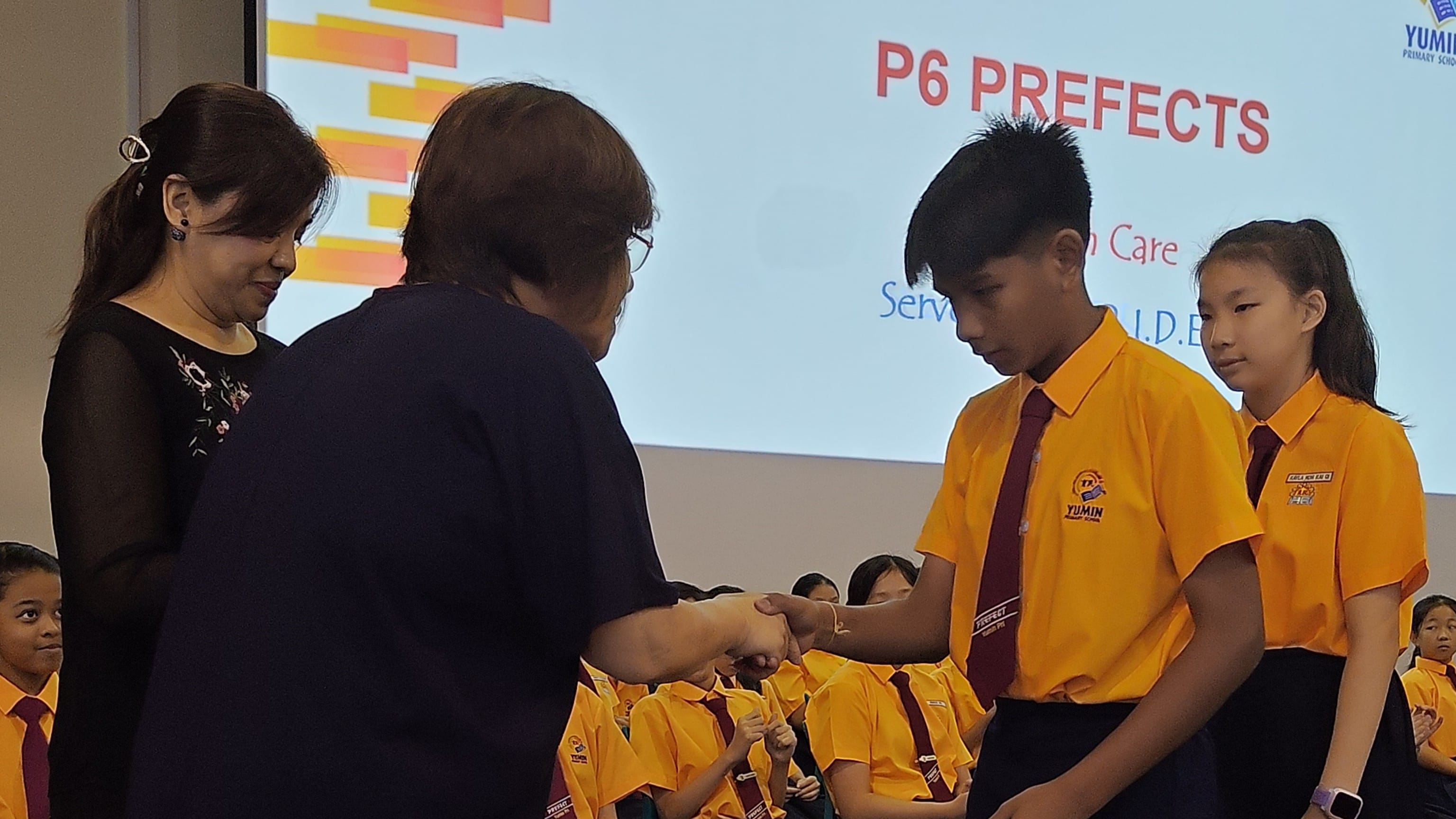 Our Principal giving pin ties to the student leaders