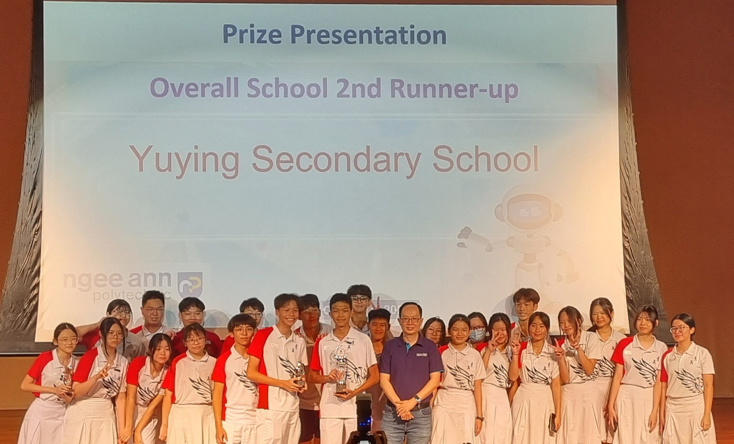 Students from Yuying Secondary School pose with trophies at a Prize Presentation for Overall School 2nd Runner-up.