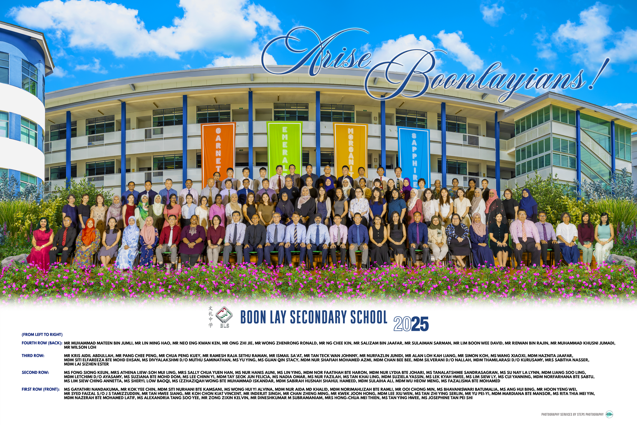 Large group photo of school staff in front of a curved building with banners and the words Arise Boonlayians!