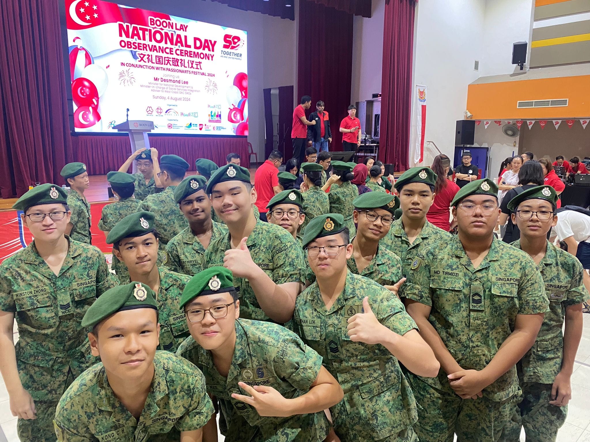 Group of young NCC cadets in camouflage uniforms and green berets posing at Boon Lay National Day Observance Ceremony.