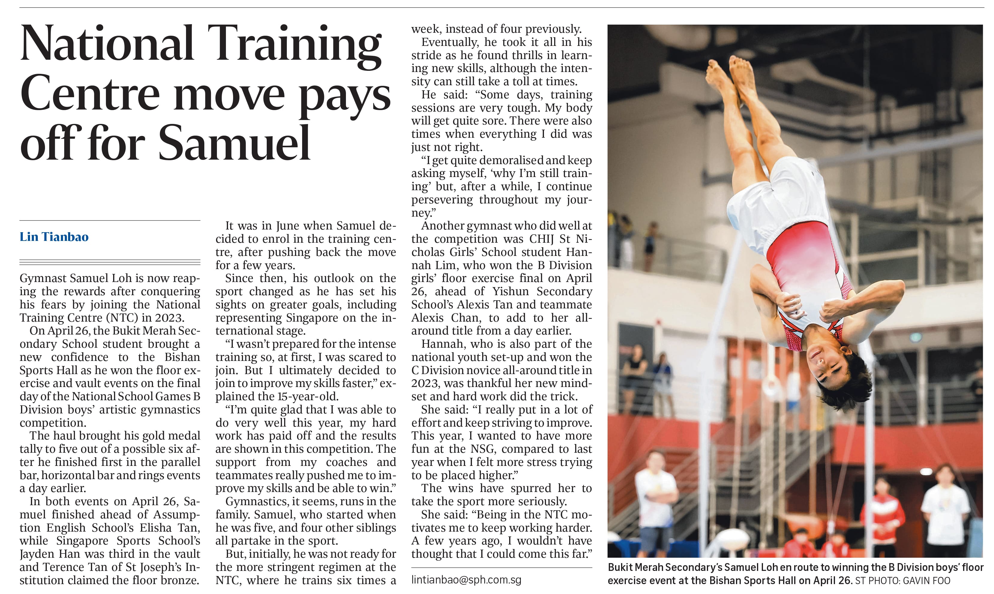 A gymnast performs an inverted aerial flip during a floor exercise competition inside a sports hall.