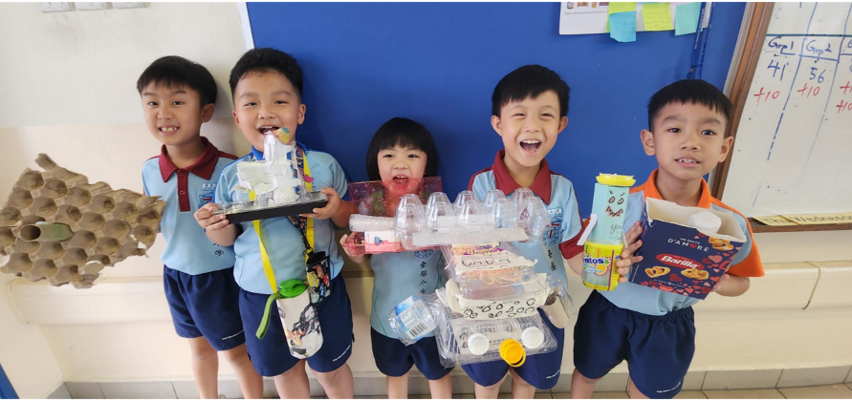 Students creating a toy from recyclable materials for their friend.