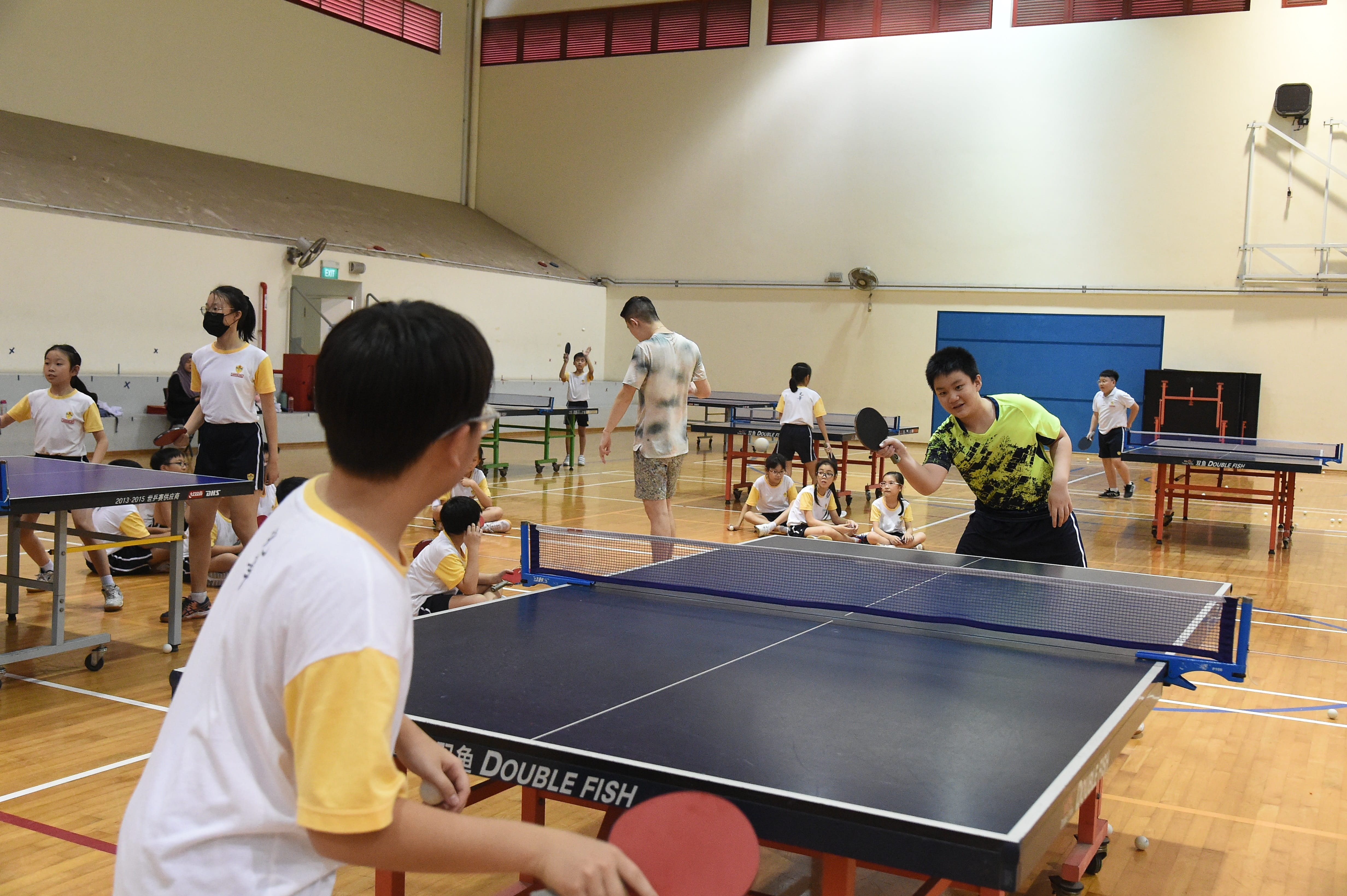 Student playing table tennis with each other