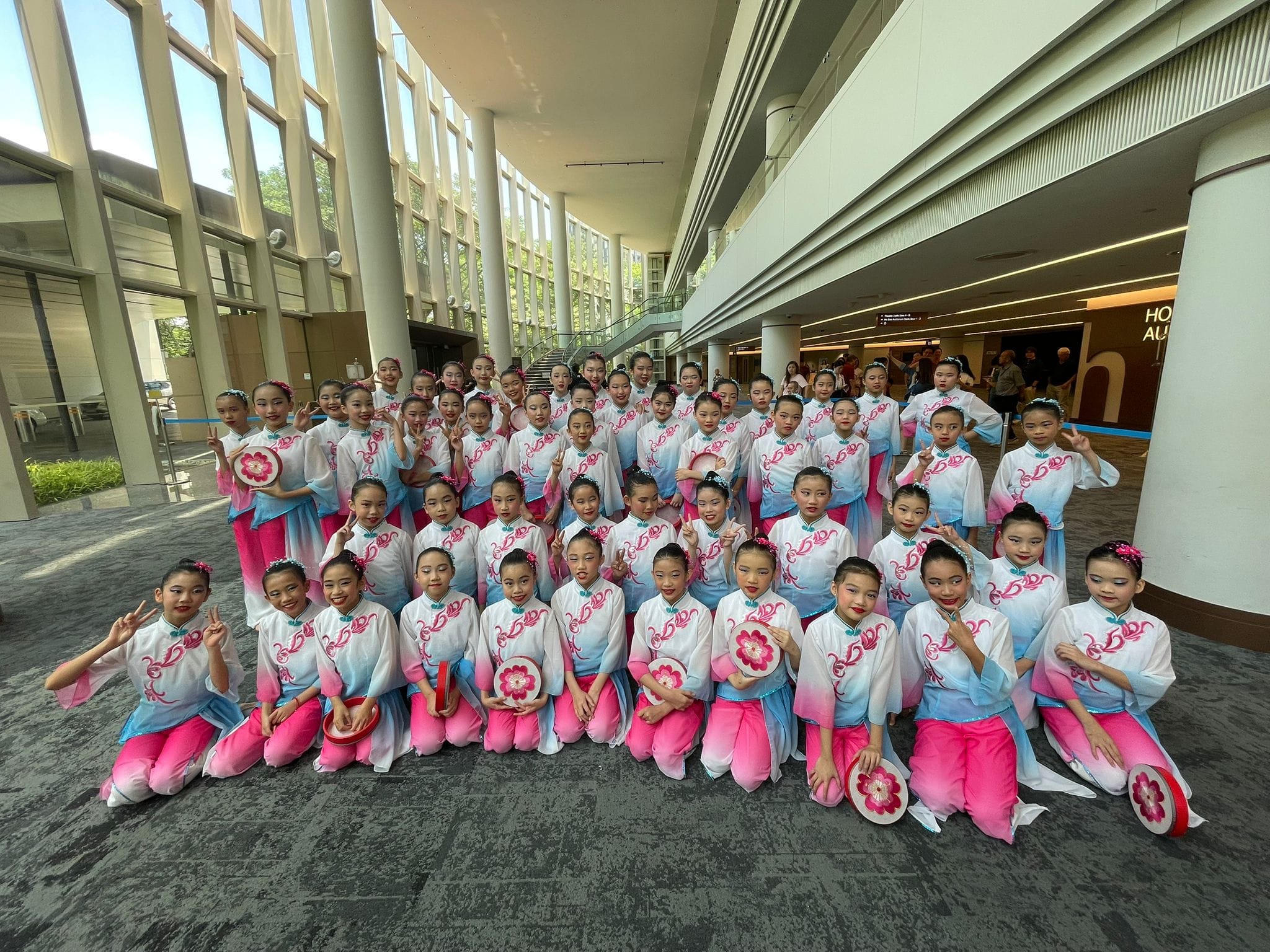 Students dressed in colourful oriental costumes posing