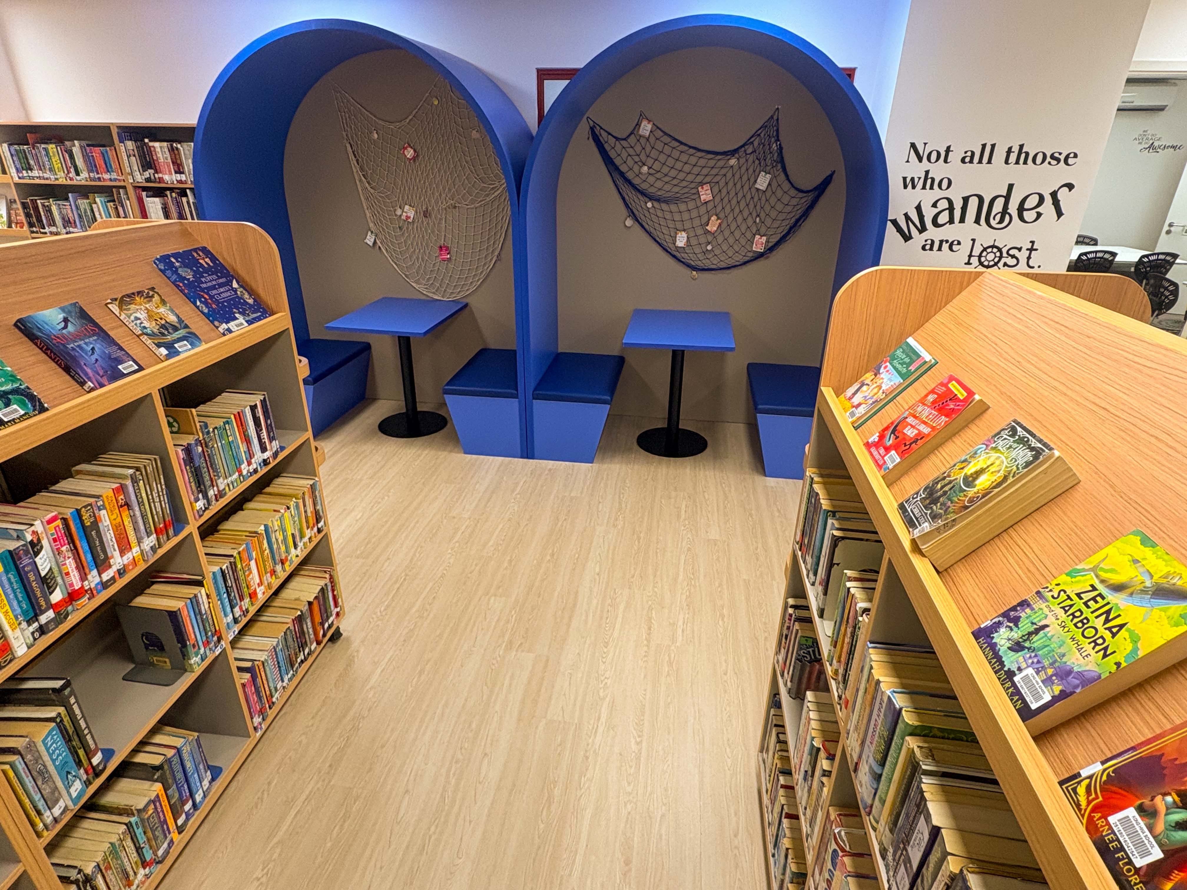 bright school library with a sea exploration theme , showing a quiet working area with desk and seating