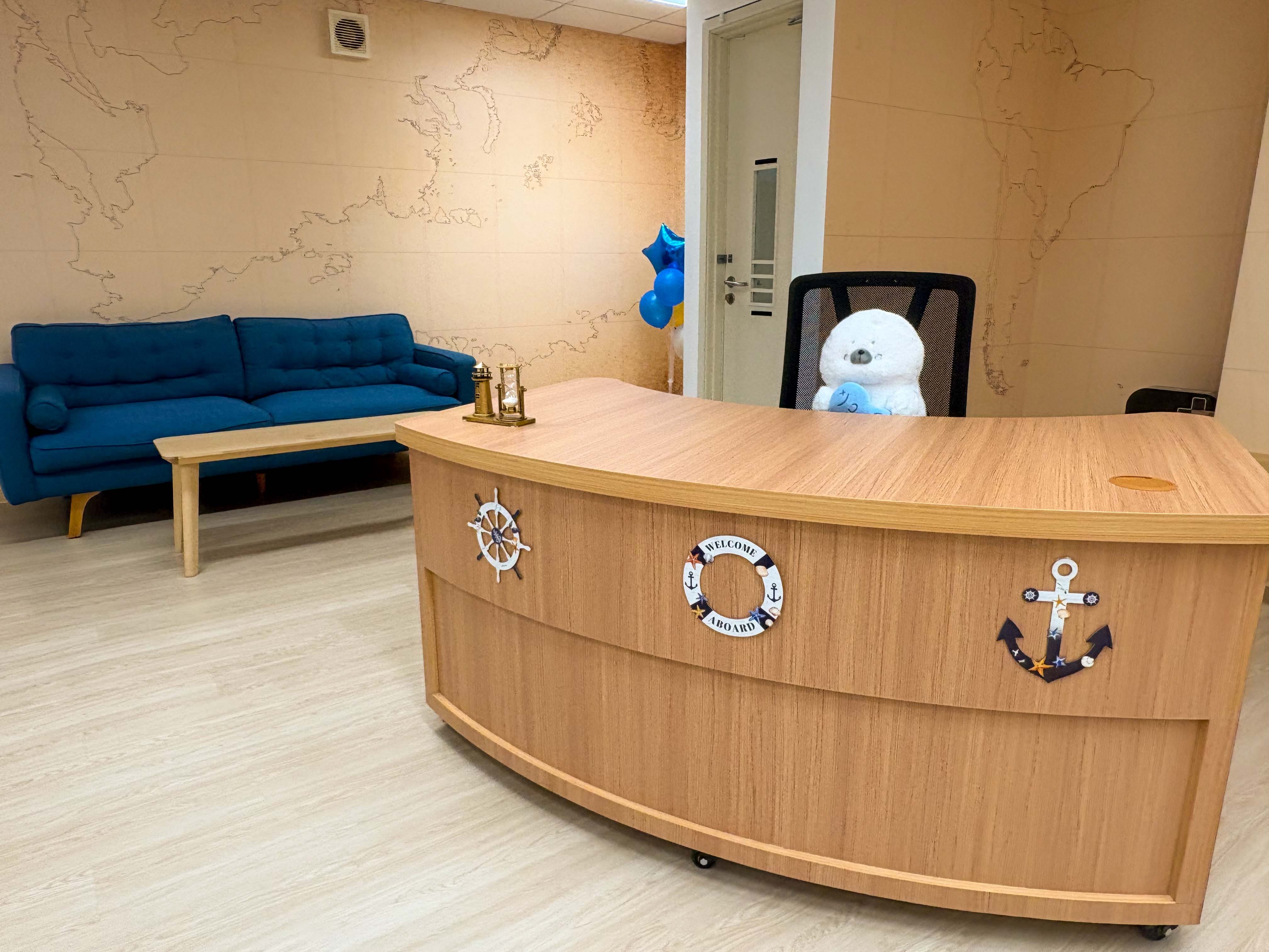 bright school library with a sea exploration theme , librarian work desk