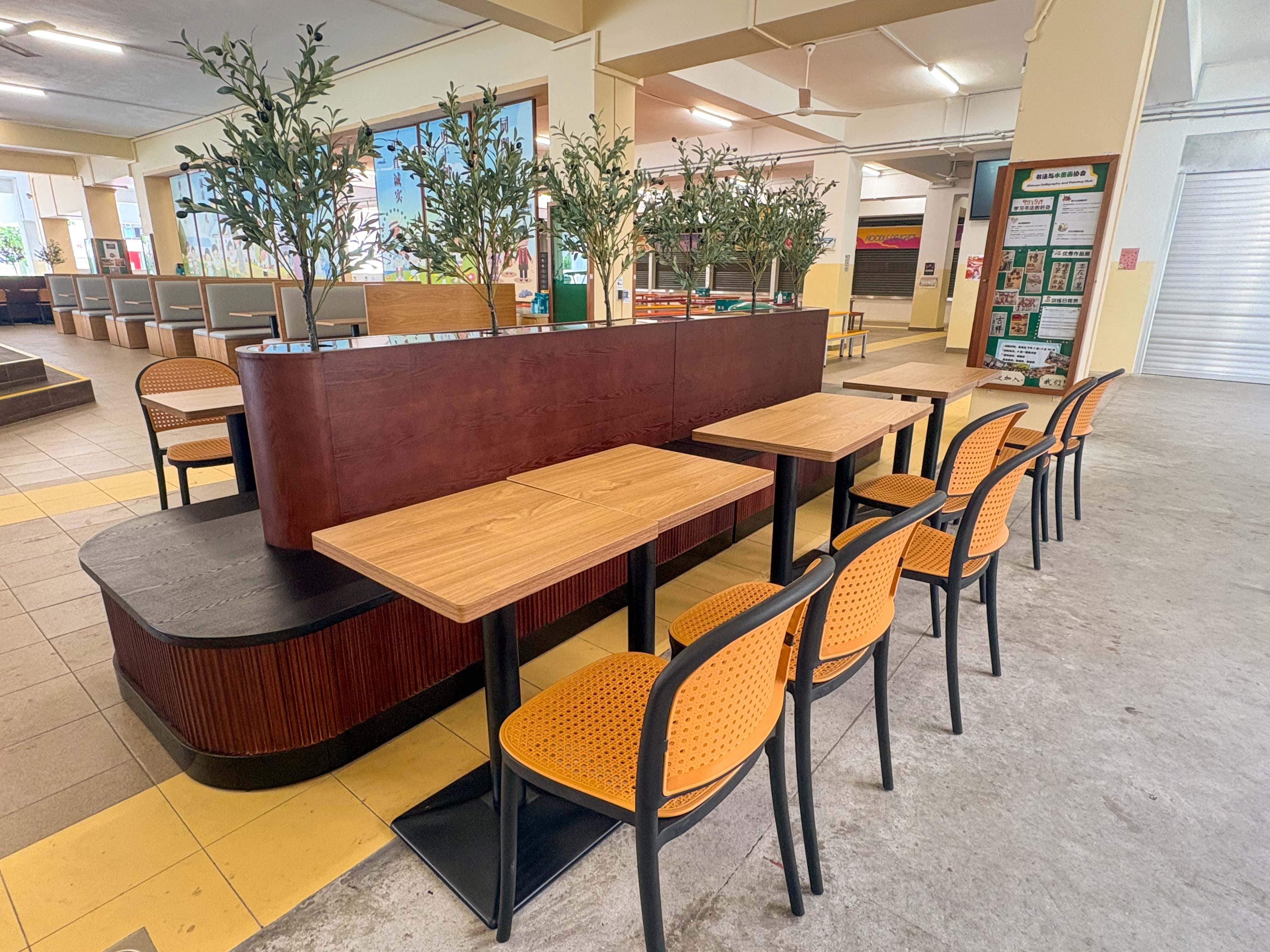 school canteen cafeteria style seating with decorative plants in another angle