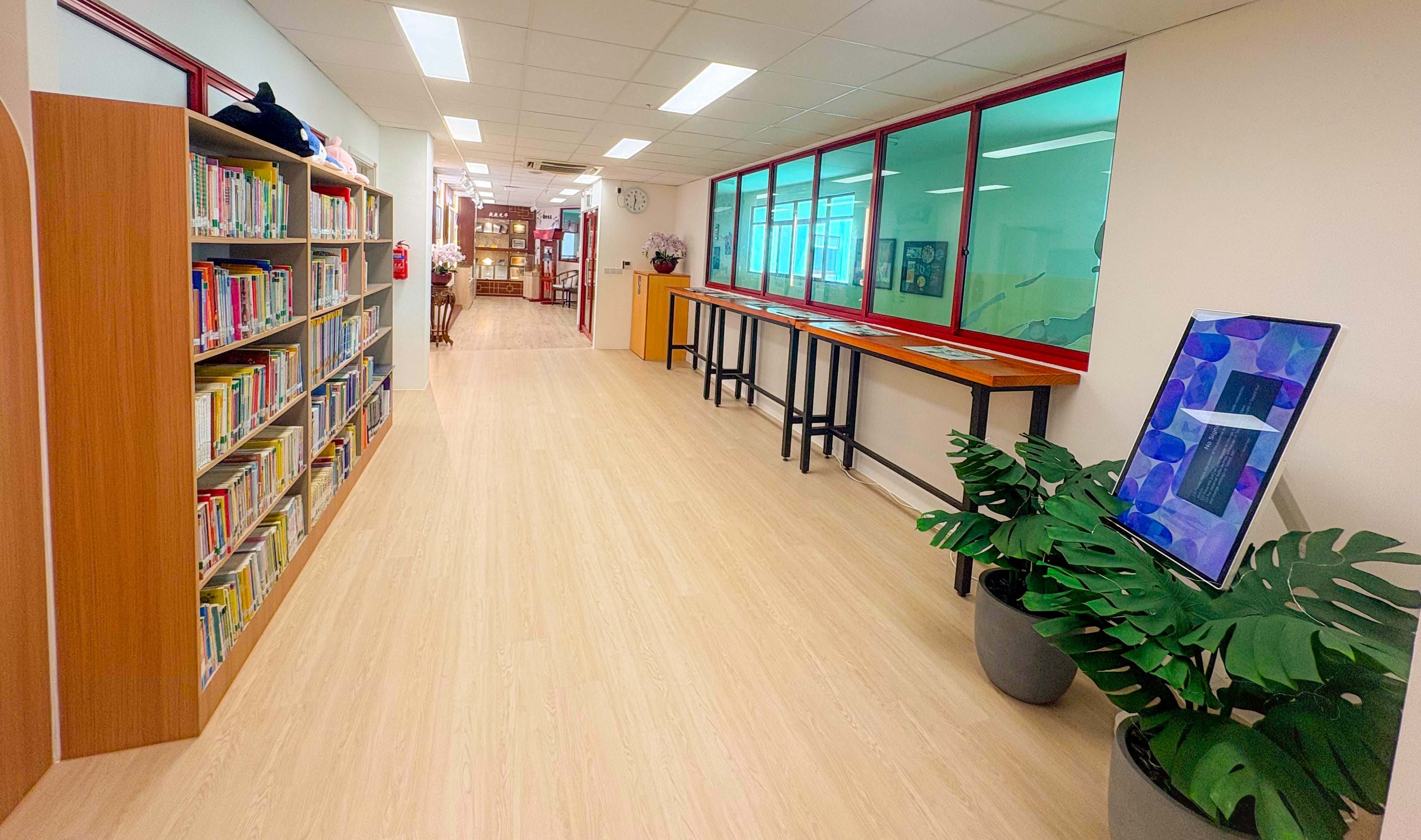 bright school library with a sea exploration theme , Tall tables facing the corridor for newspaper reading