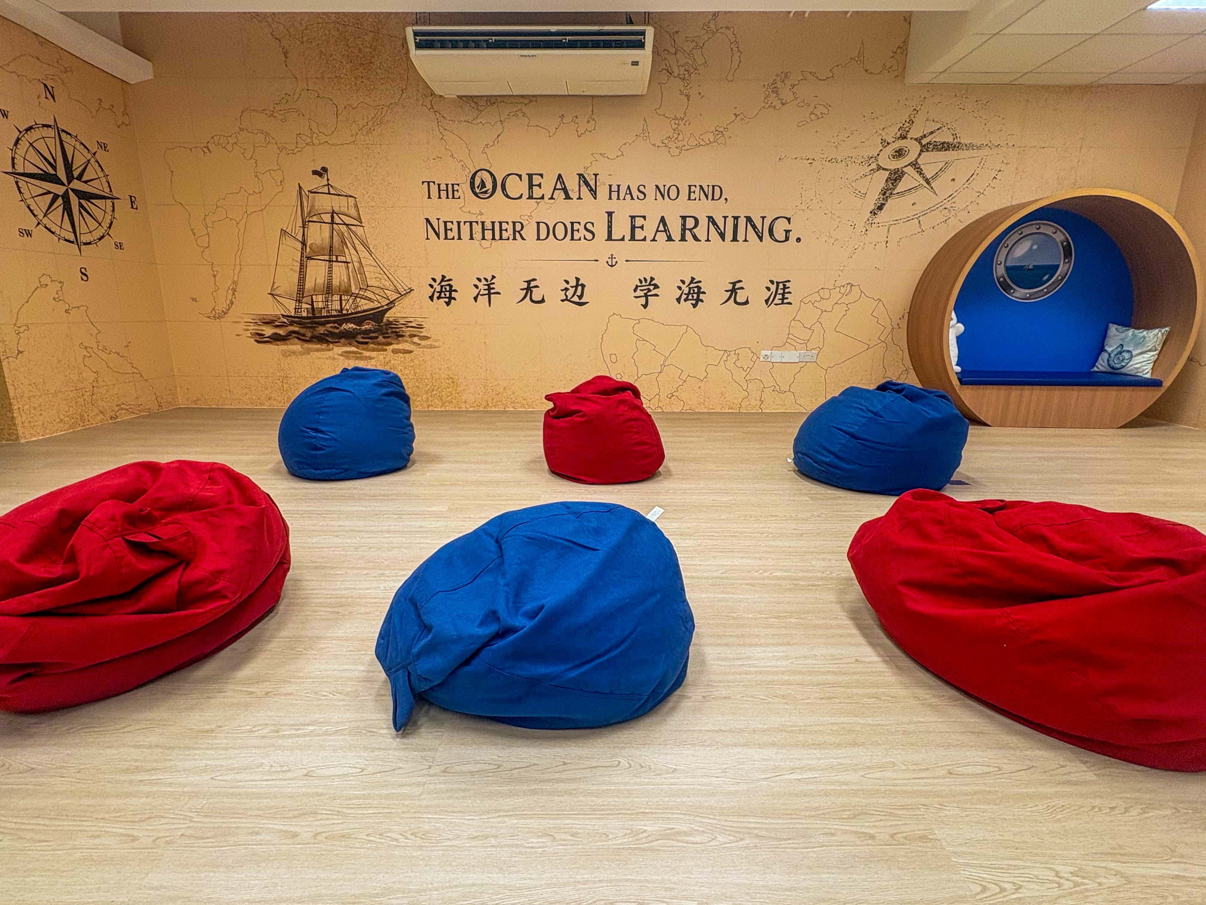 bright school library with a sea exploration theme , beanbags for students to chill and read