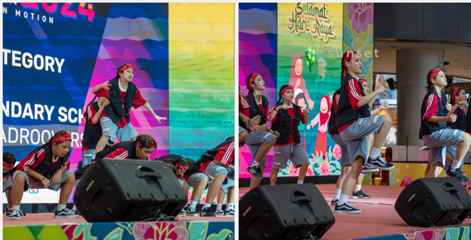Youth dancers in matching red and black outfits perform on a colorful stage during a Hari Raya event.