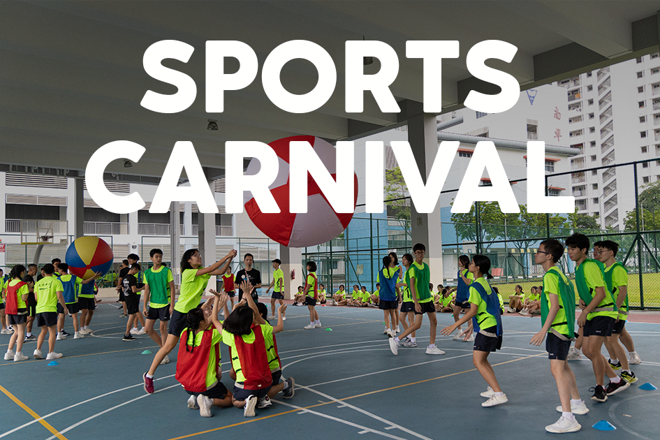 Students in neon green vests play with large colorful balls on an outdoor court at a Sports Carnival event.