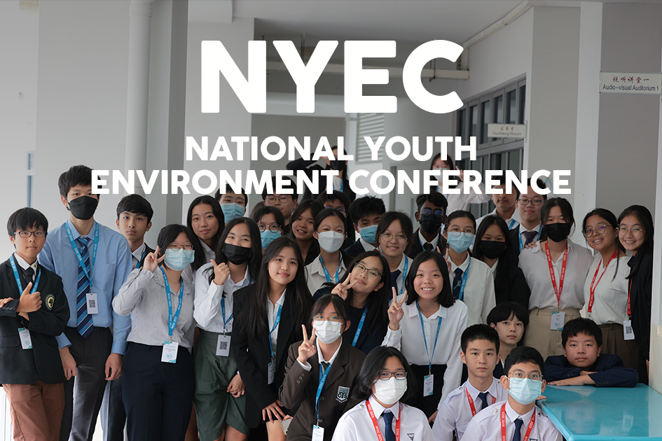 A group of students wearing lanyards and face masks pose together at the National Youth Environment Conference.
