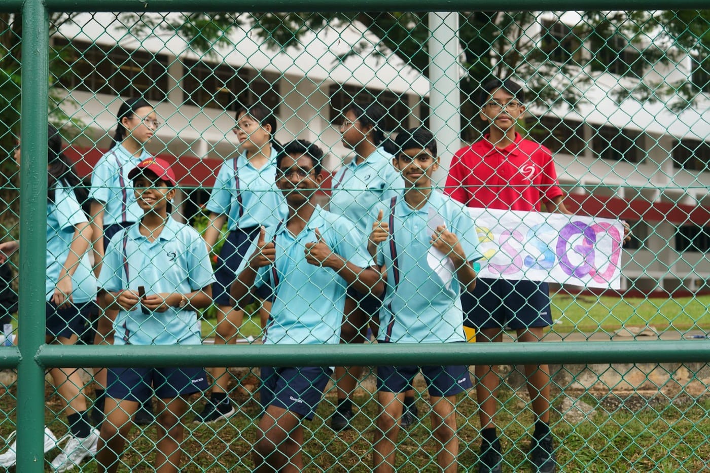 Students pressed against the courtside railing cheering on their classmates.