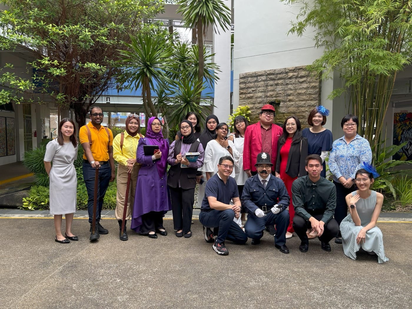 English teachers dressed as Cluedo characters posing together outdoors on ELLE Day.