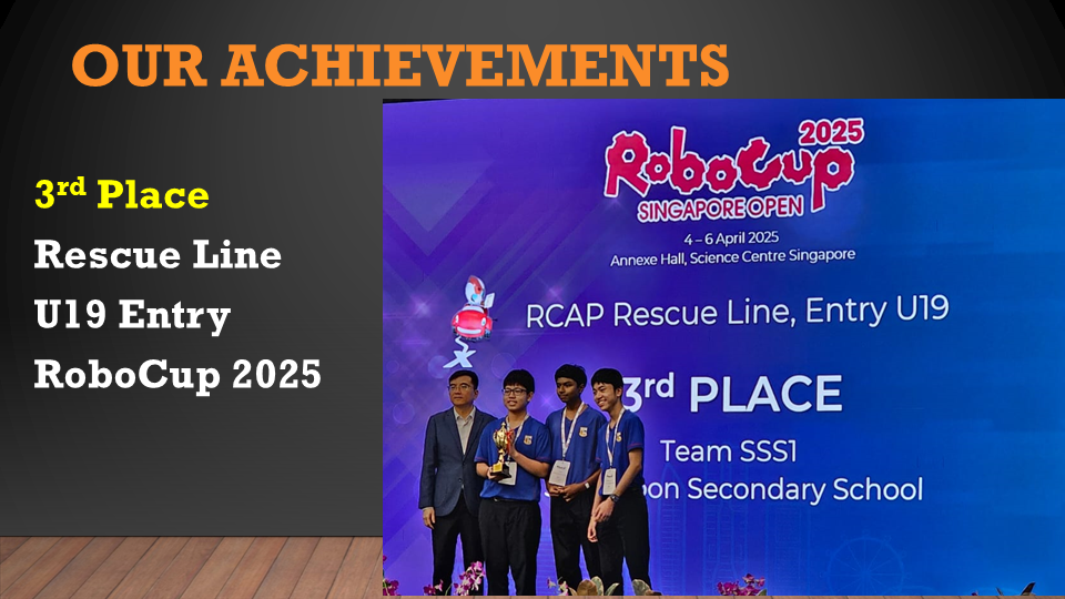 Three students and an adult pose on stage after winning 3rd place at RoboCup Singapore Open 2025.