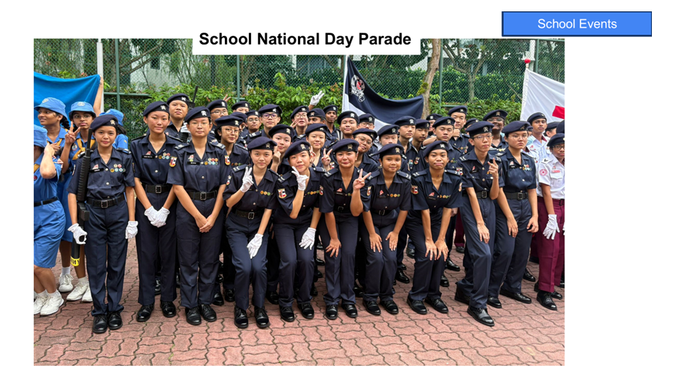 Students in dark navy uniforms and berets pose as a group outdoors during a School National Day Parade.