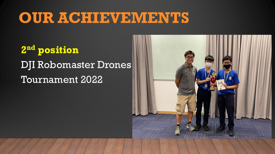 Three boys posing with a trophy, celebrating 2nd place at DJI Robomaster Drones Tournament 2022.