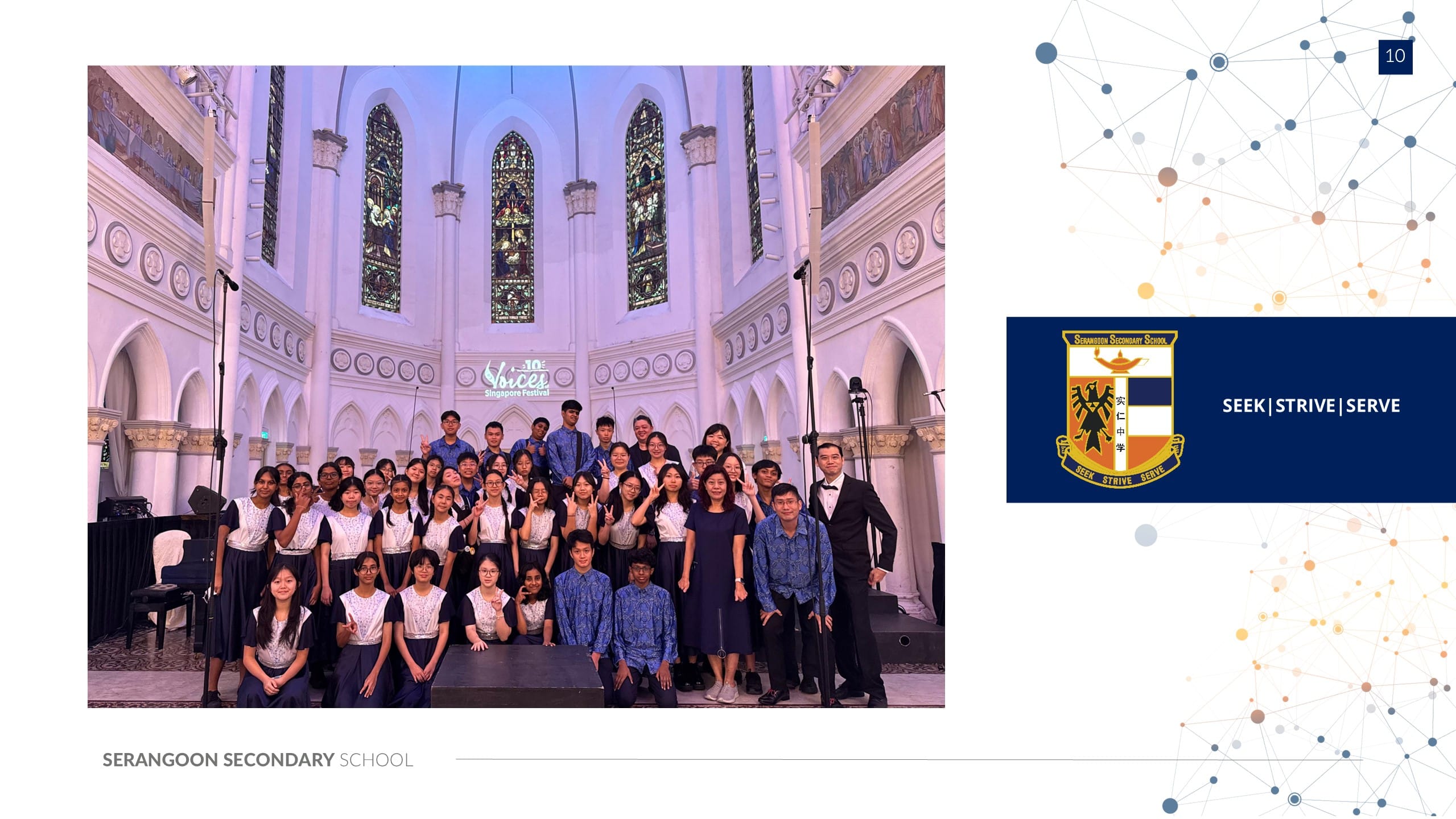 A large student choir group poses inside a grand cathedral with stained glass windows at the Voices Singapore Festival.