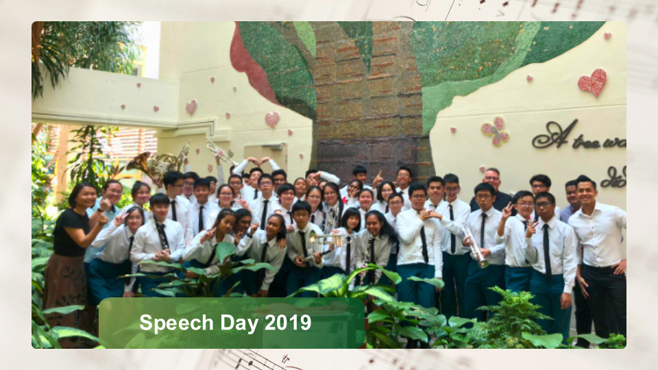 Group photo of band members in formal white shirts and ties posing in front of a tree mosaic wall for Speech Day 2019.