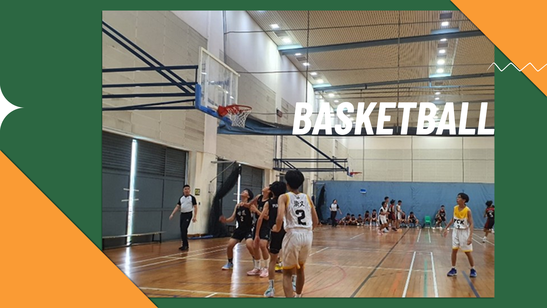 Action photo of basketball players competing for a rebound directly under the hoop during a game.