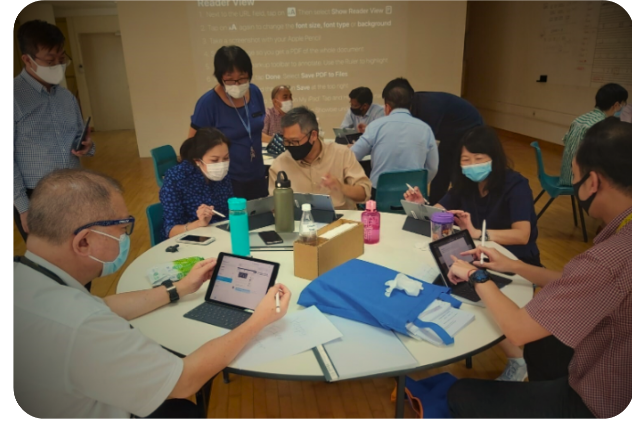 Some people huddling over computing devices