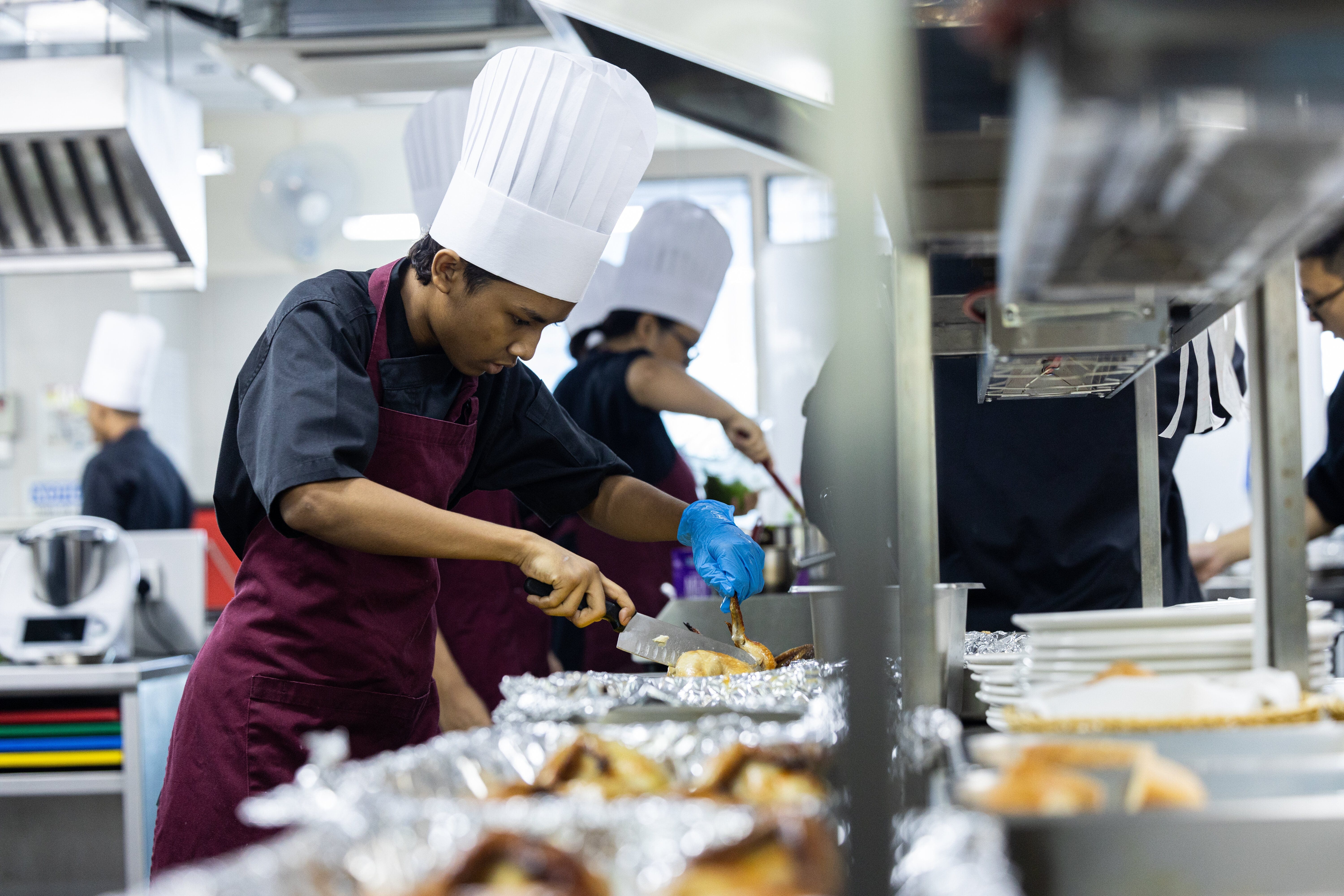 students preparing a meal in the kitchen