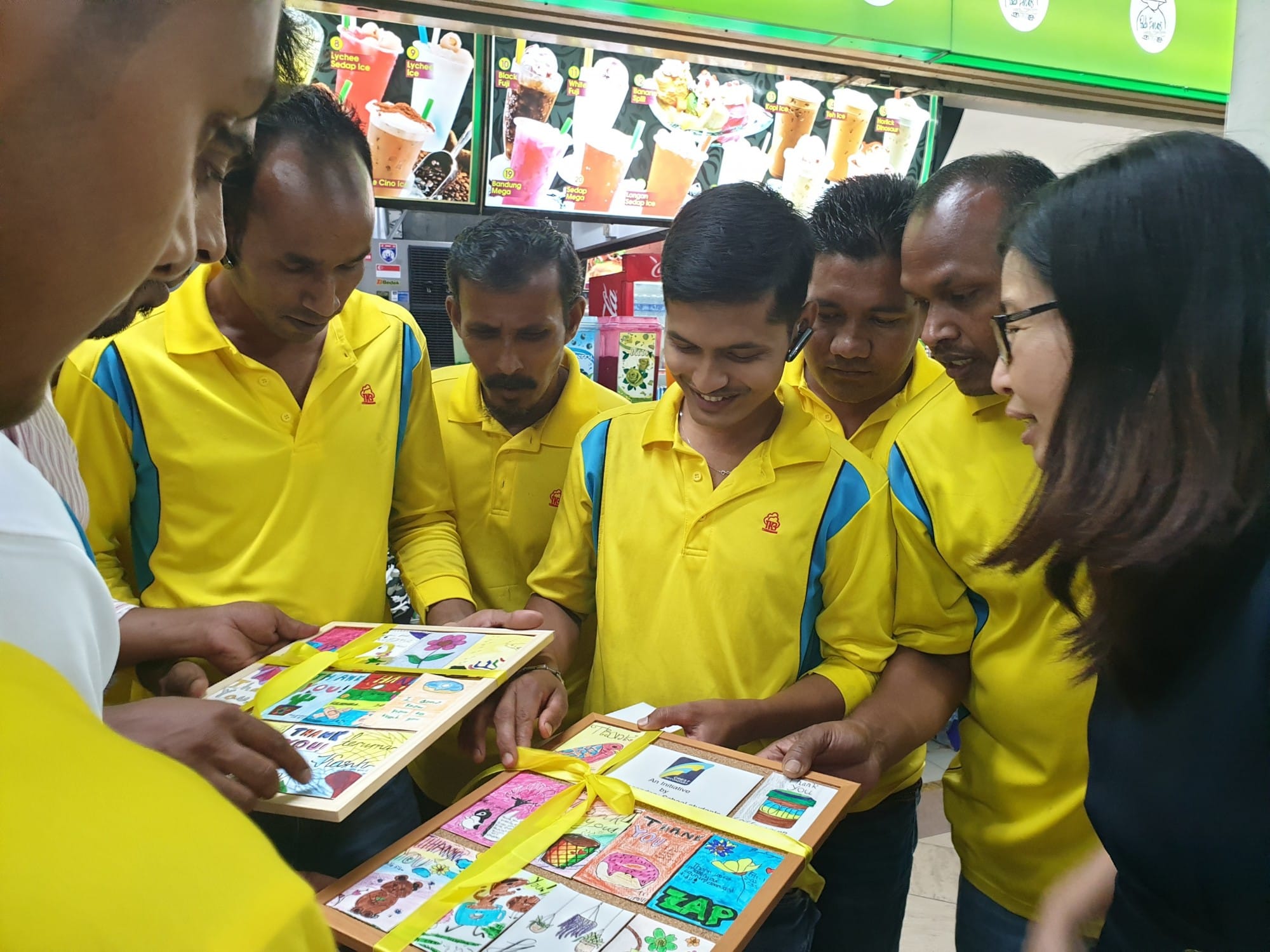 group of visitors at a stall looking at artwork
