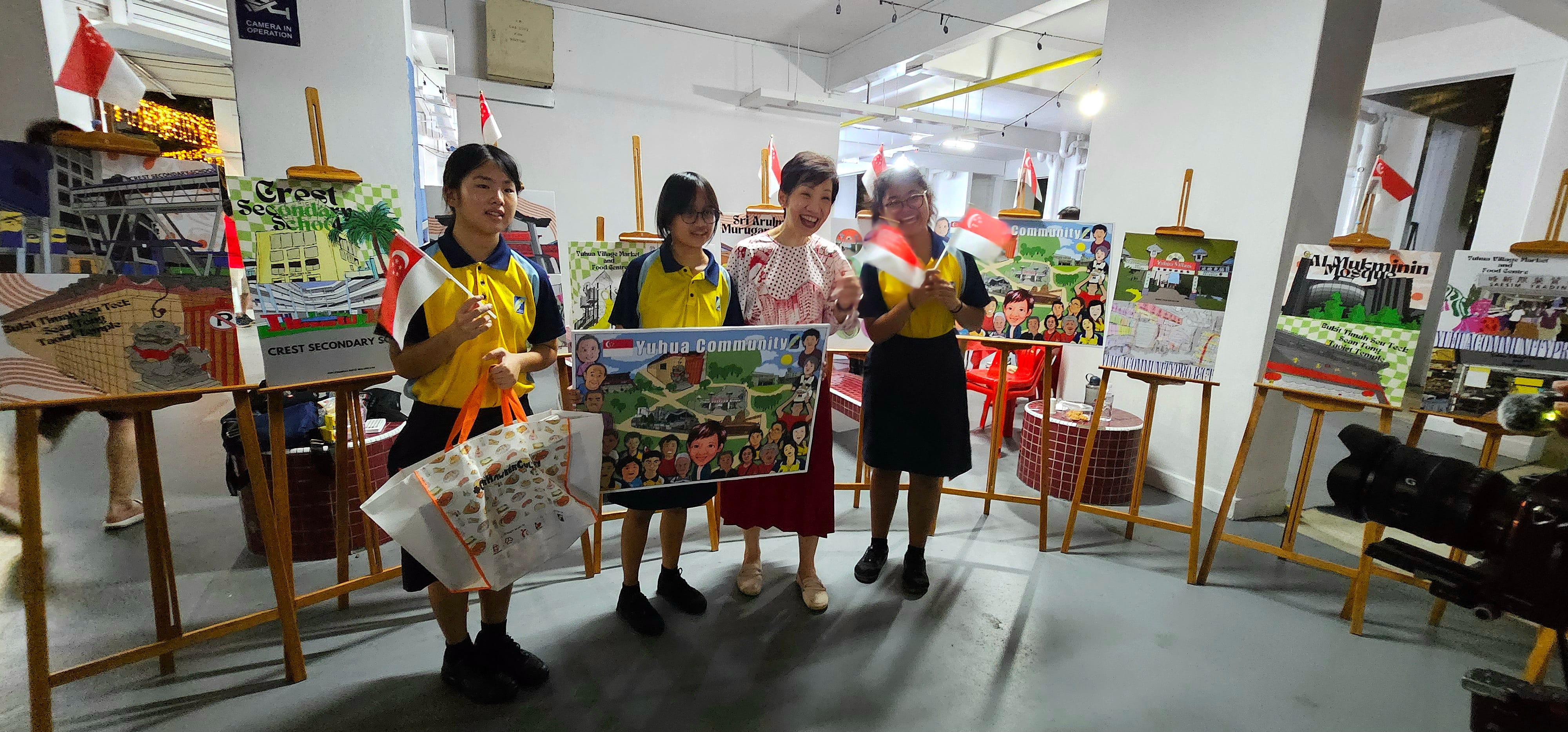 students posing with artwork