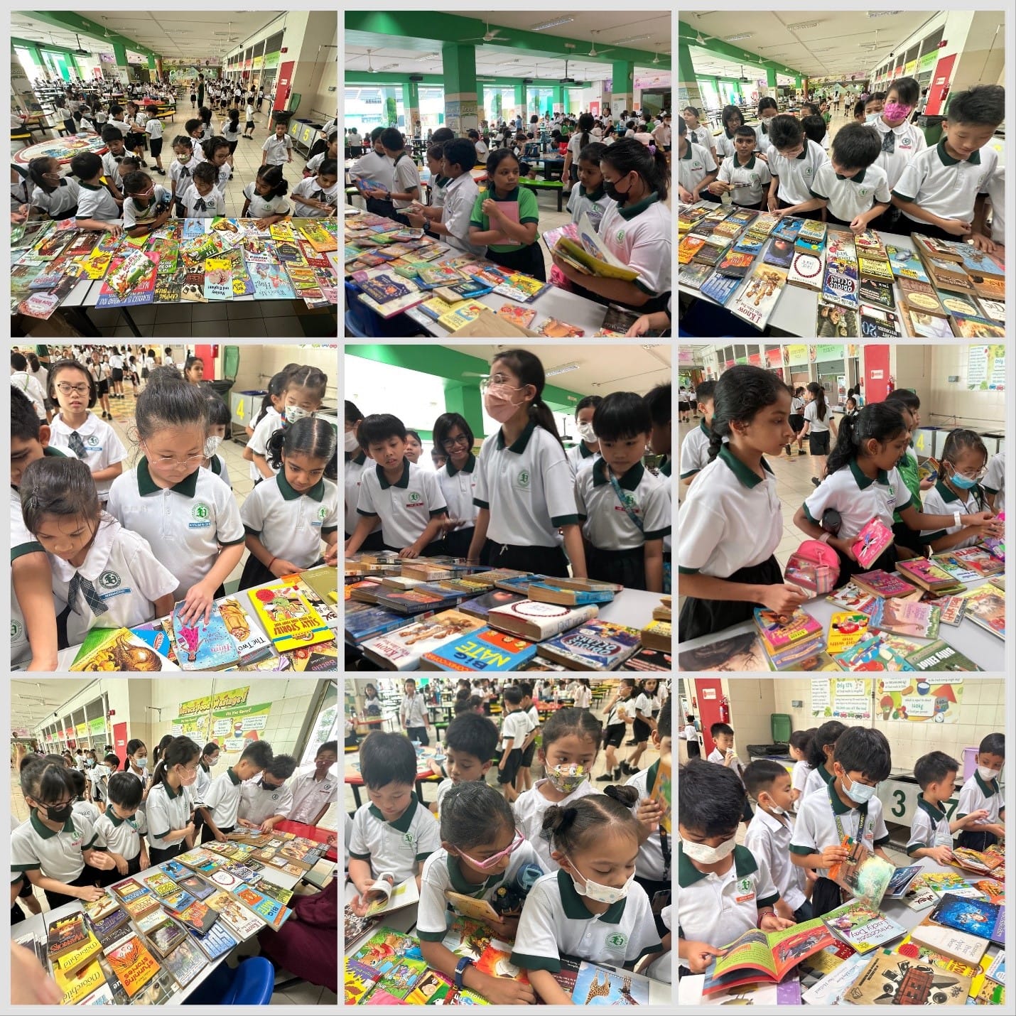 School children in white and green uniforms browse and read colorful books spread on tables in a large hall.