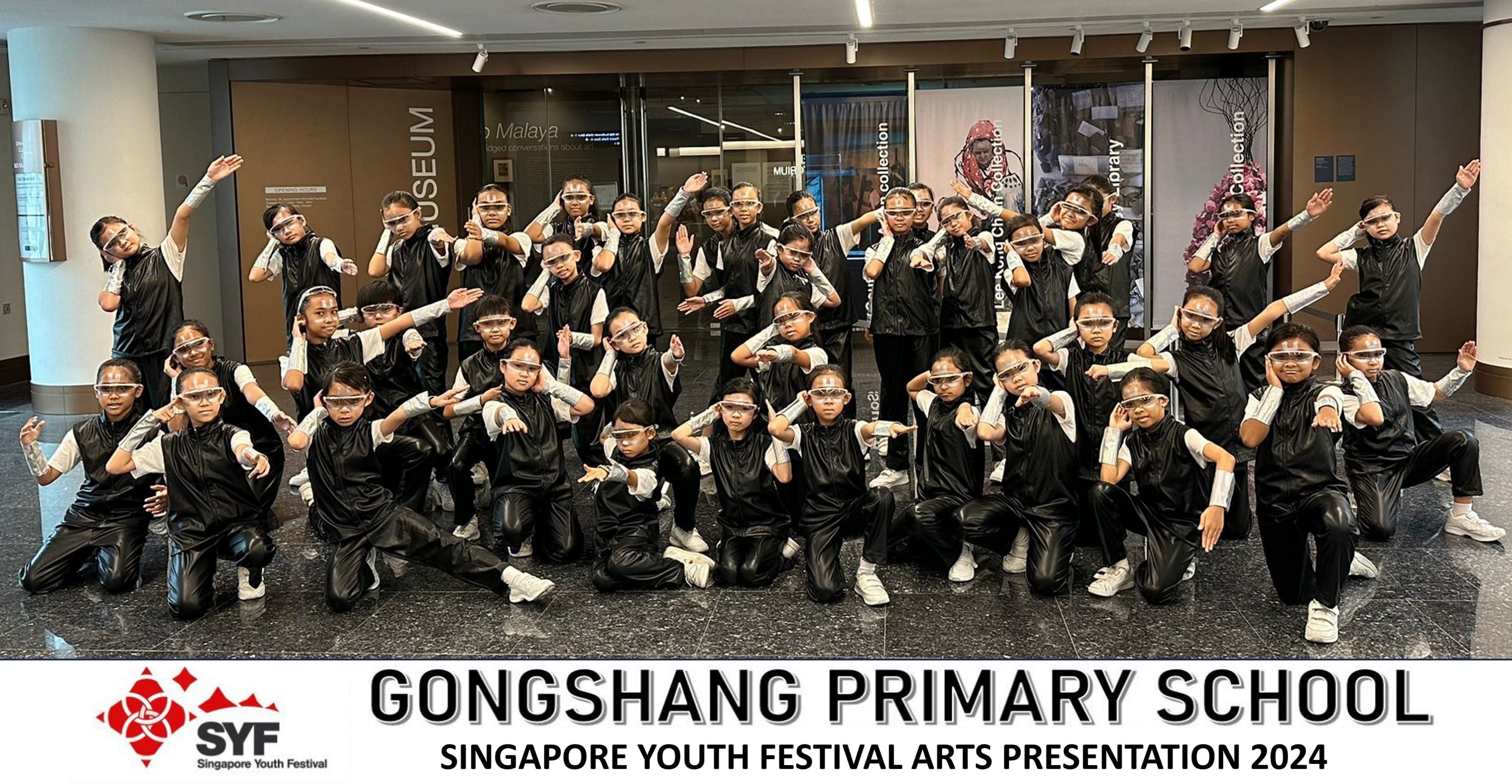Group of children in black costumes and goggles posing for Gongshang Primary School SYF Arts Presentation 2024.