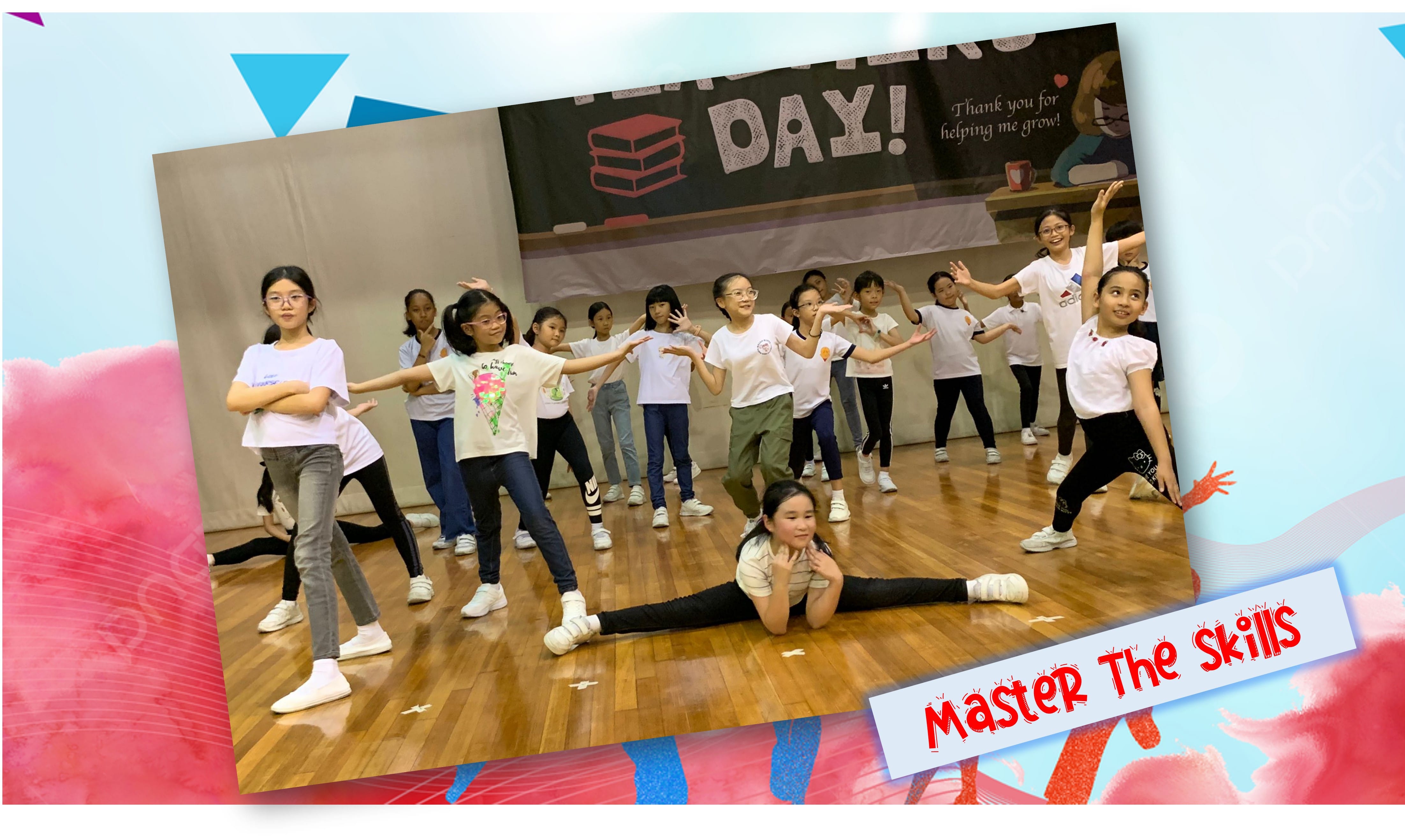 Children in white shirts perform a dance routine on a wooden floor in front of a Teacher's Day banner.