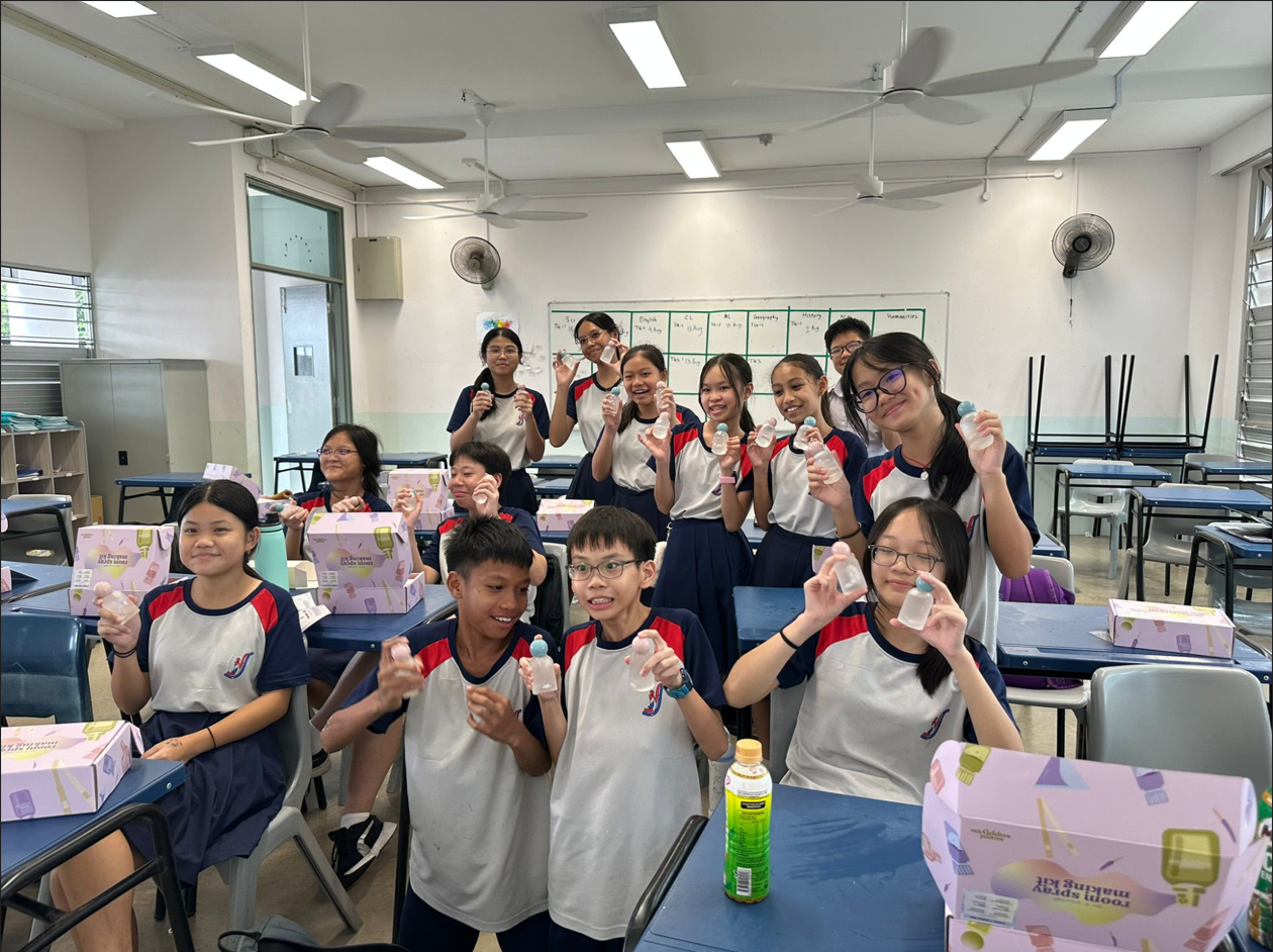 A group photo of students holding the DIY perfume