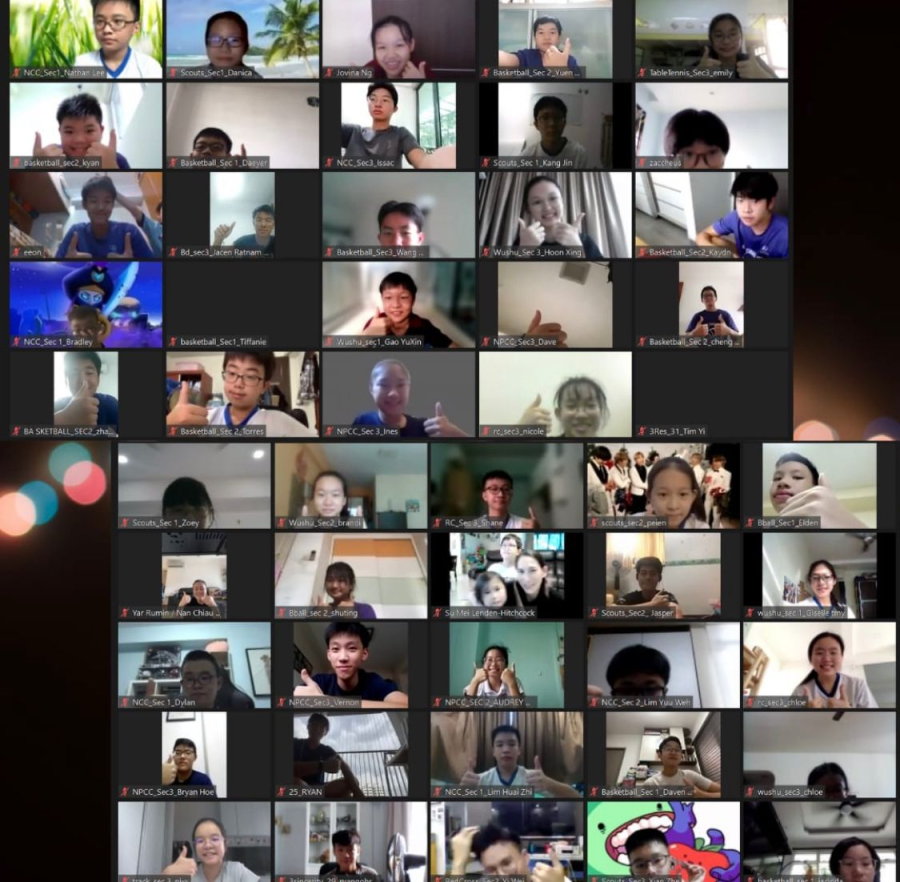 A grid of over 40 students on a video call, each shown in small labeled tiles waving or posing.