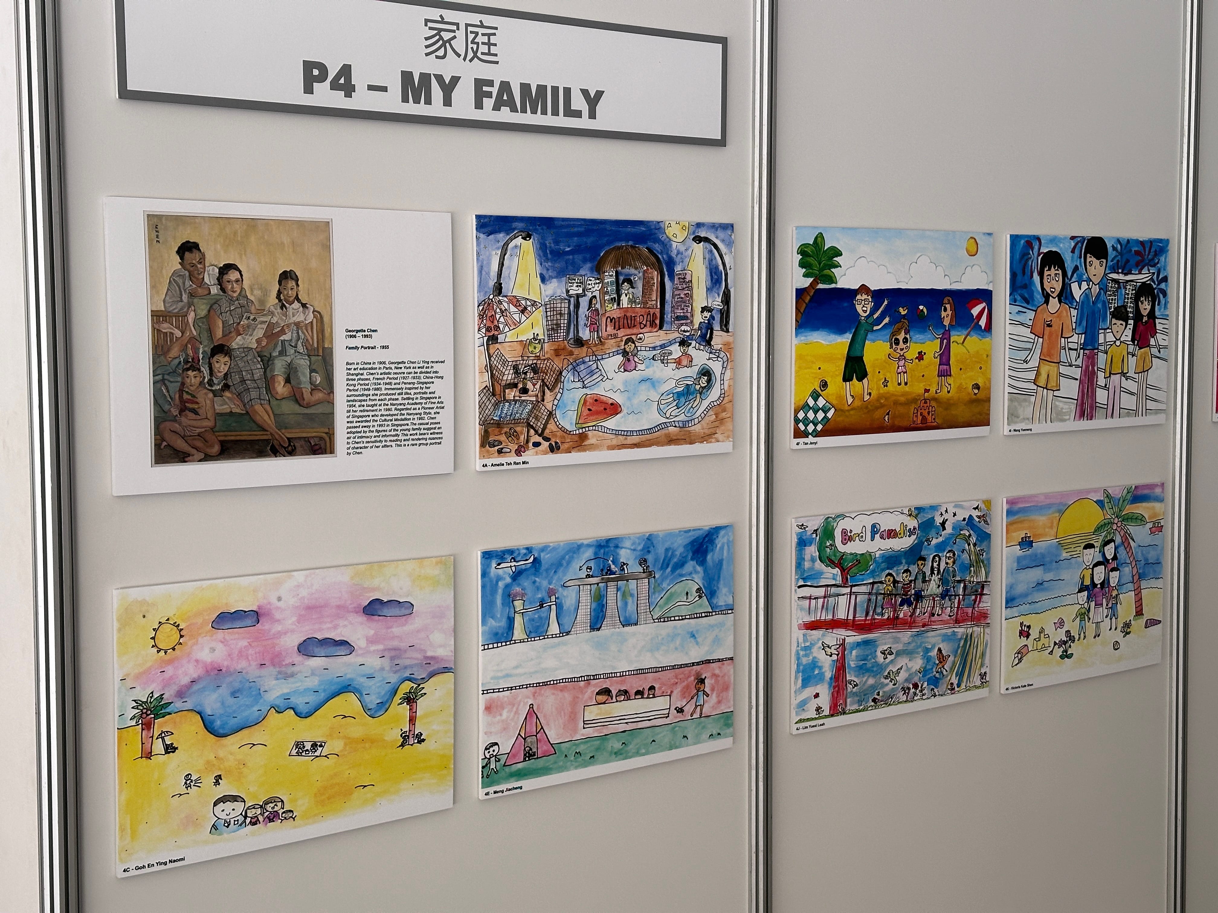 A school art display titled P4 My Family showing colorful children's drawings and one classic painting of a family.