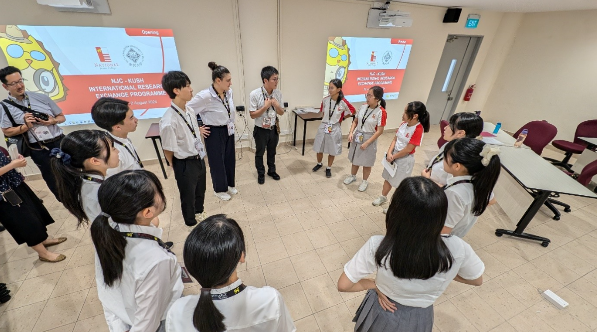 Students and teachers stand in a circle during the NJC-KUSH International Research Exchange Programme opening in 2024.