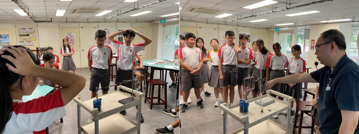 Students in school uniforms react with surprise during a science demonstration by a teacher in a classroom lab.